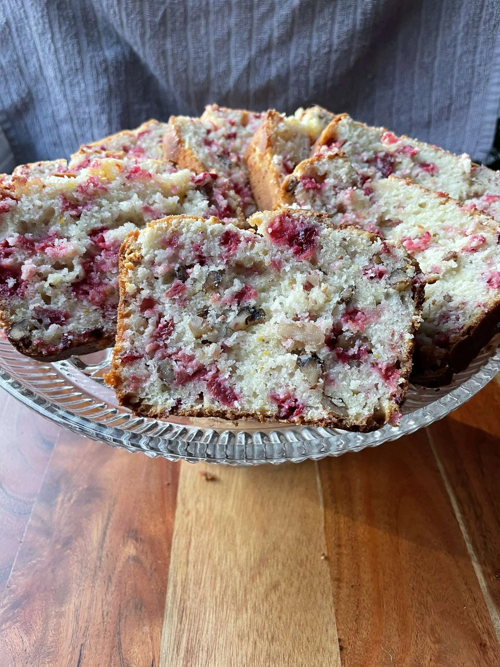 Cranberry orange bread on a glass platter
