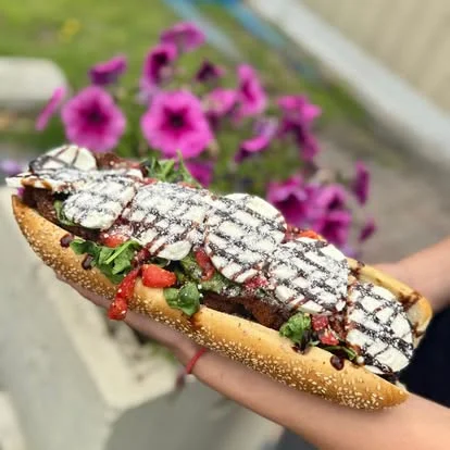 Delicious Mexican torta with grilled meat and fresh toppings