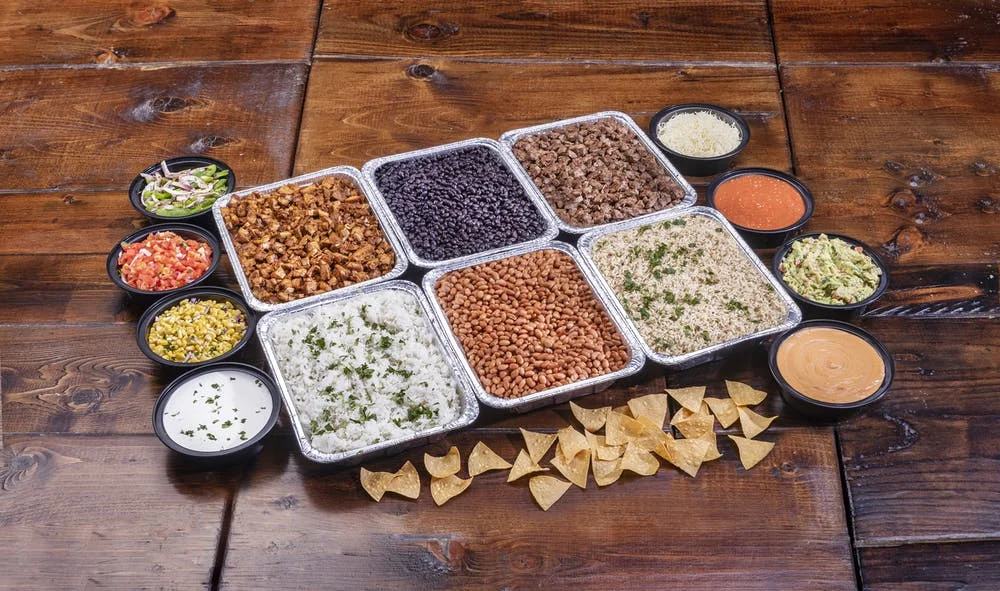 A beautifully arranged catering spread with various dishes and garnishes.