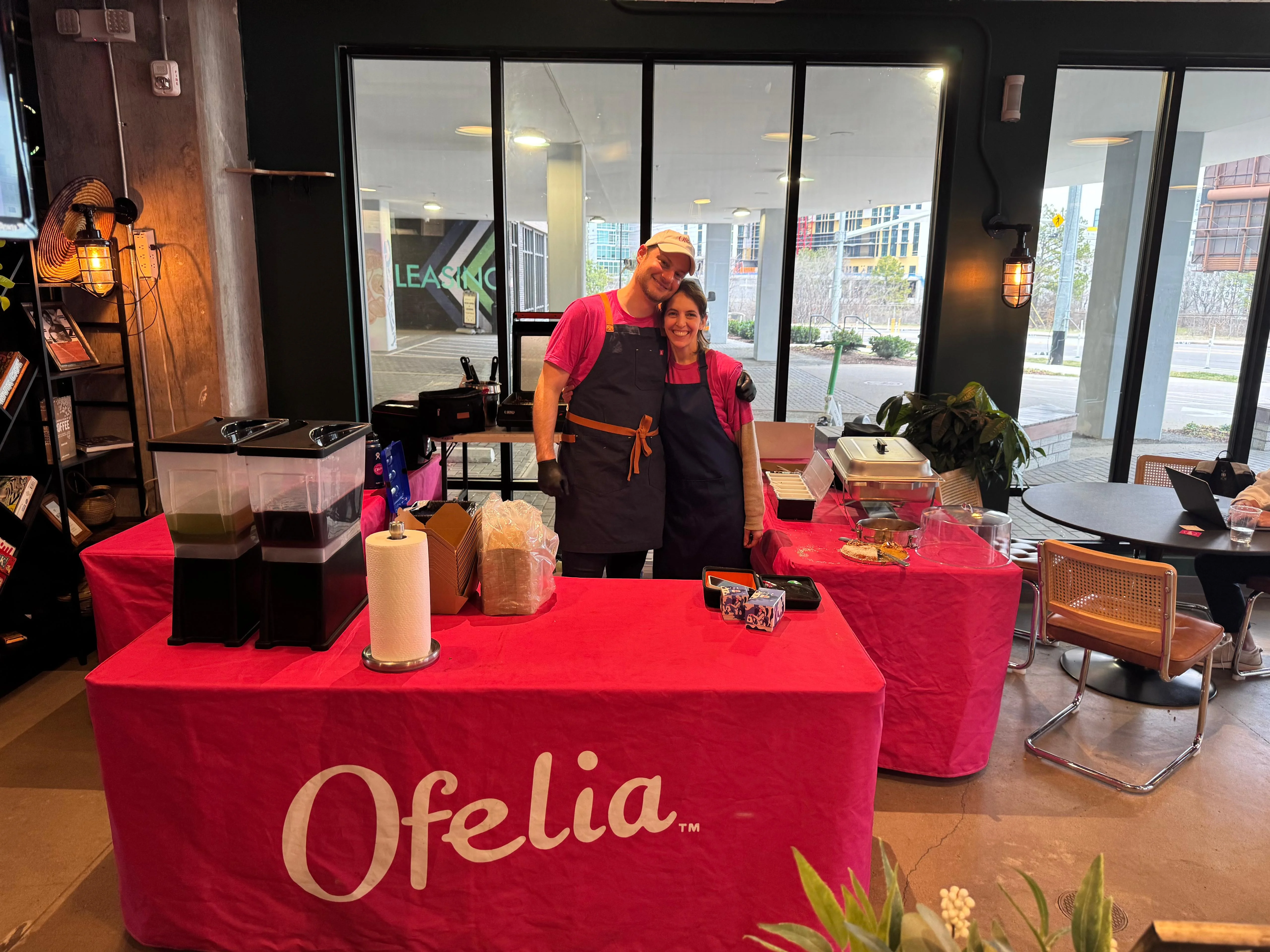 Vibrant food stall with cheerful staff serving drinks