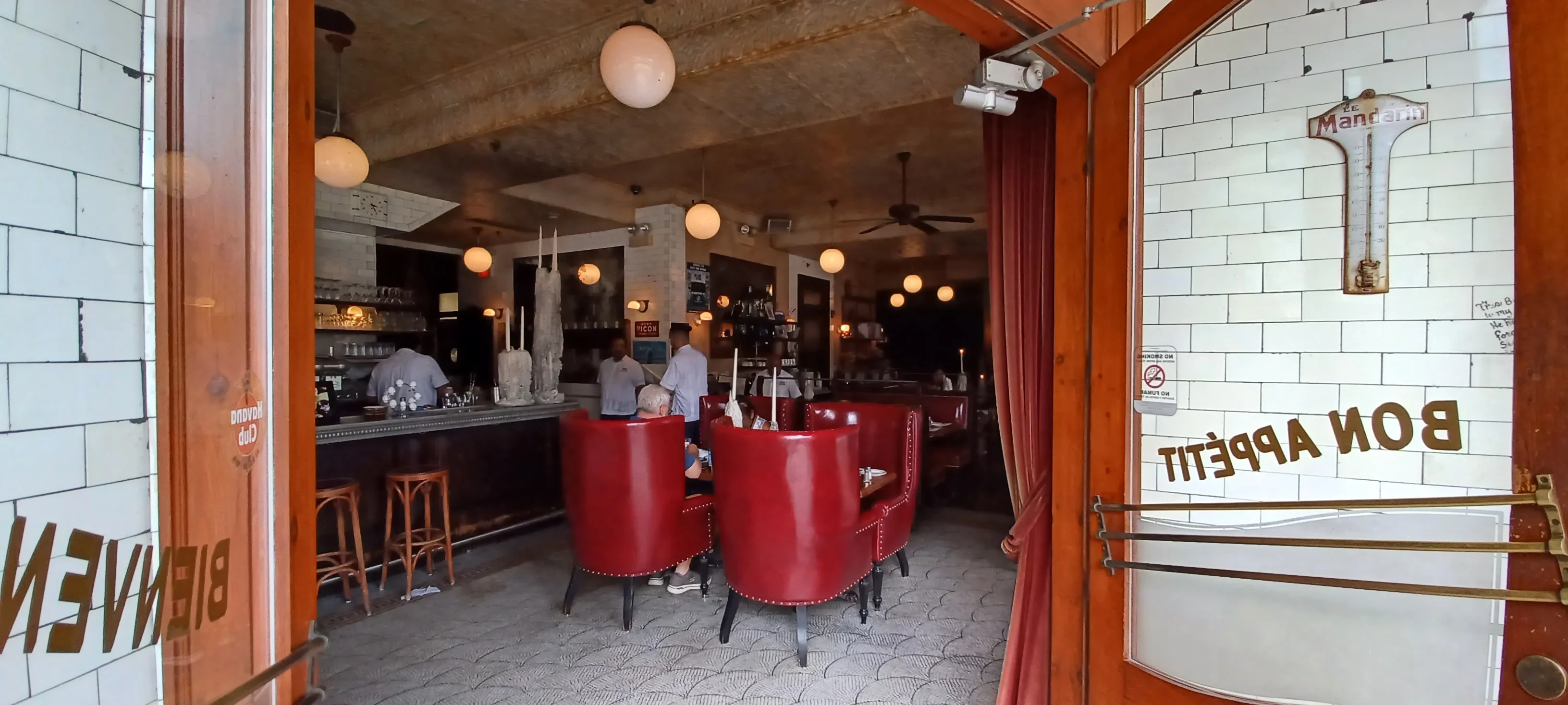 Charming restaurant interior with red chairs and warm lighting