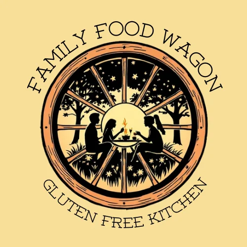 An illustrative logo featuring two silhouettes sitting around a fire in a circular design that includes stars and trees. The text 'Family Food Wagon' and 'Gluten Free Kitchen' is prominently displayed.