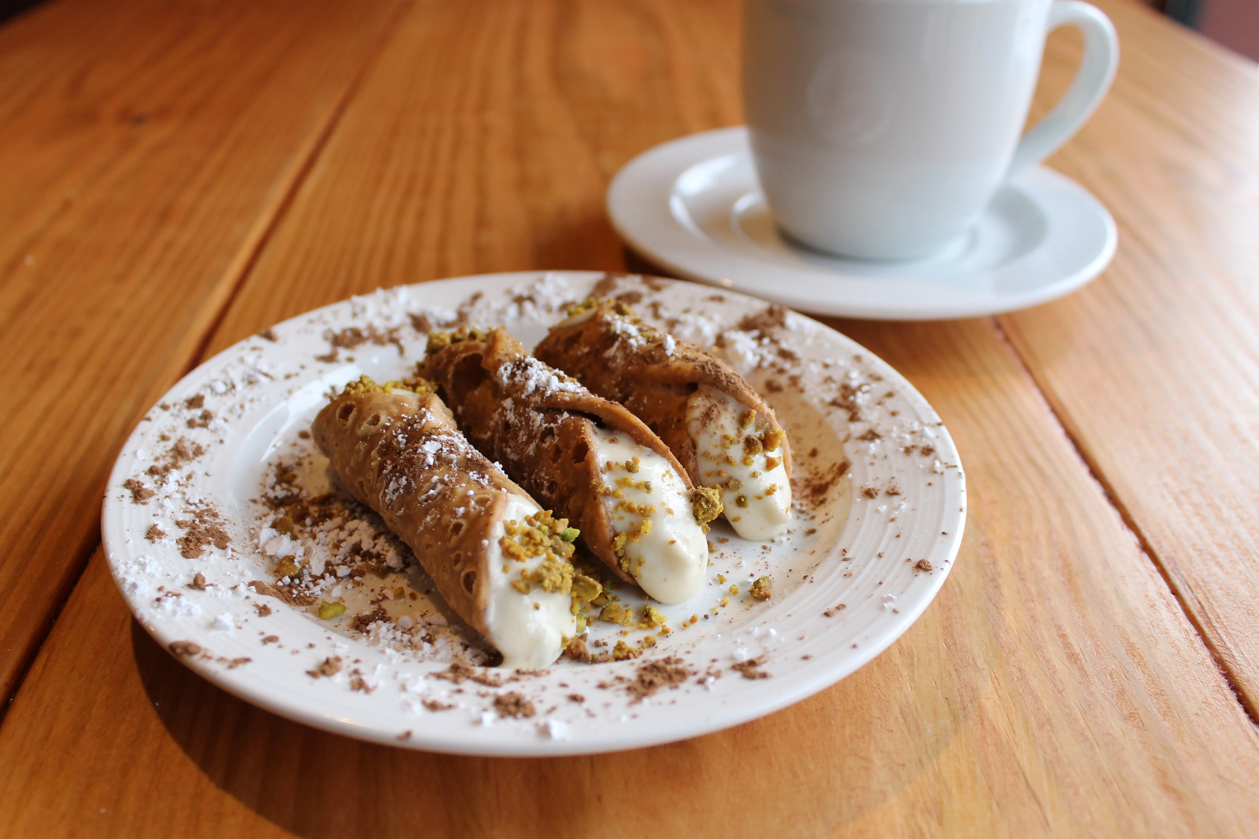 Italian cannoli dessert with pistachios and cocoa powder