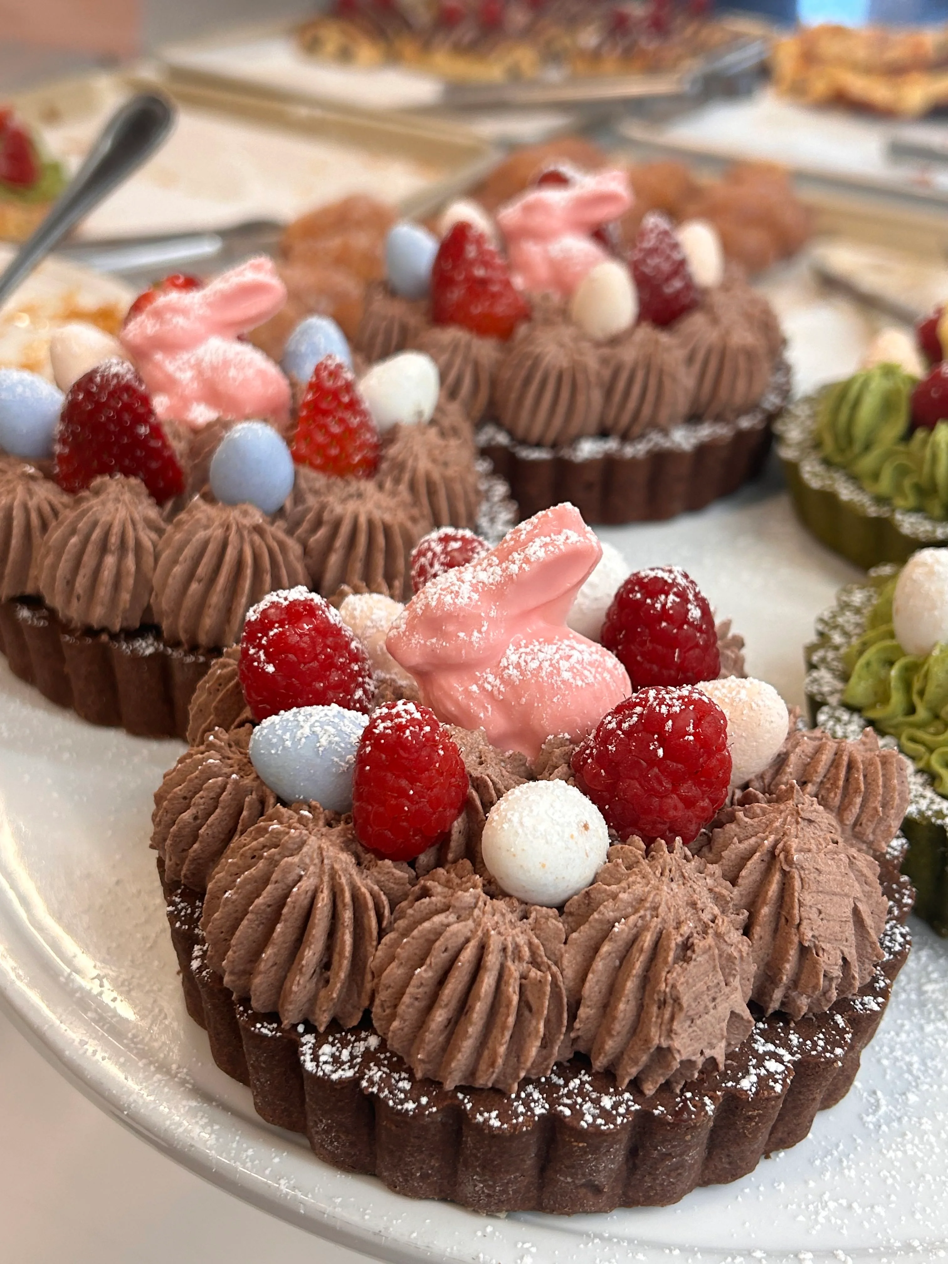 Chocolate tart with berries and pastel decorations
