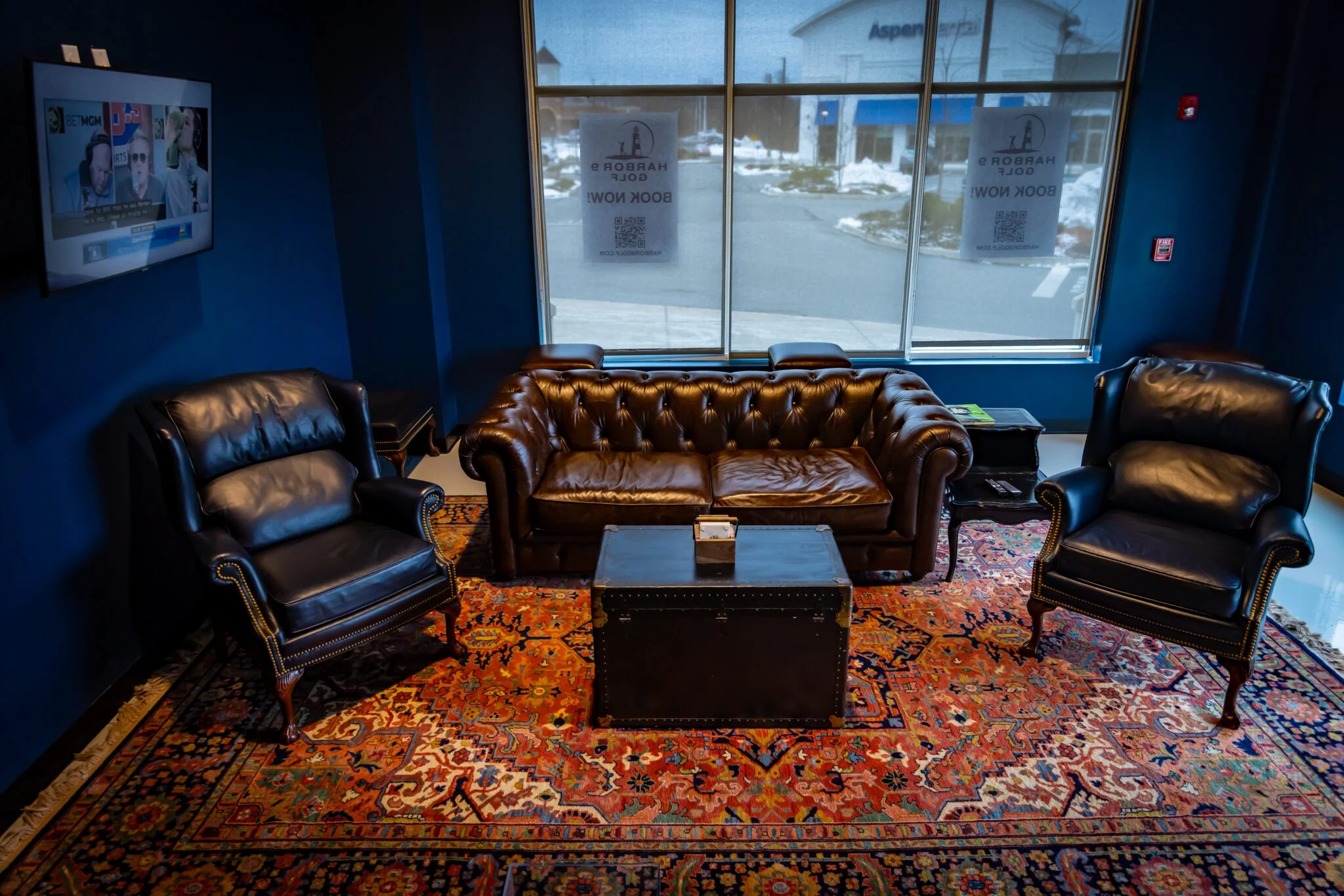 Cozy lounge area with leather seating and decorative rug