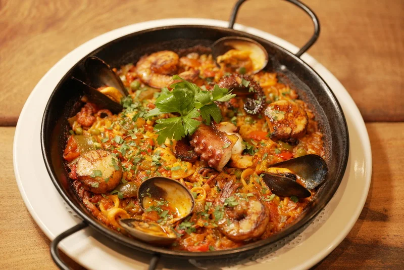 Traditional Spanish paella with seafood and herbs