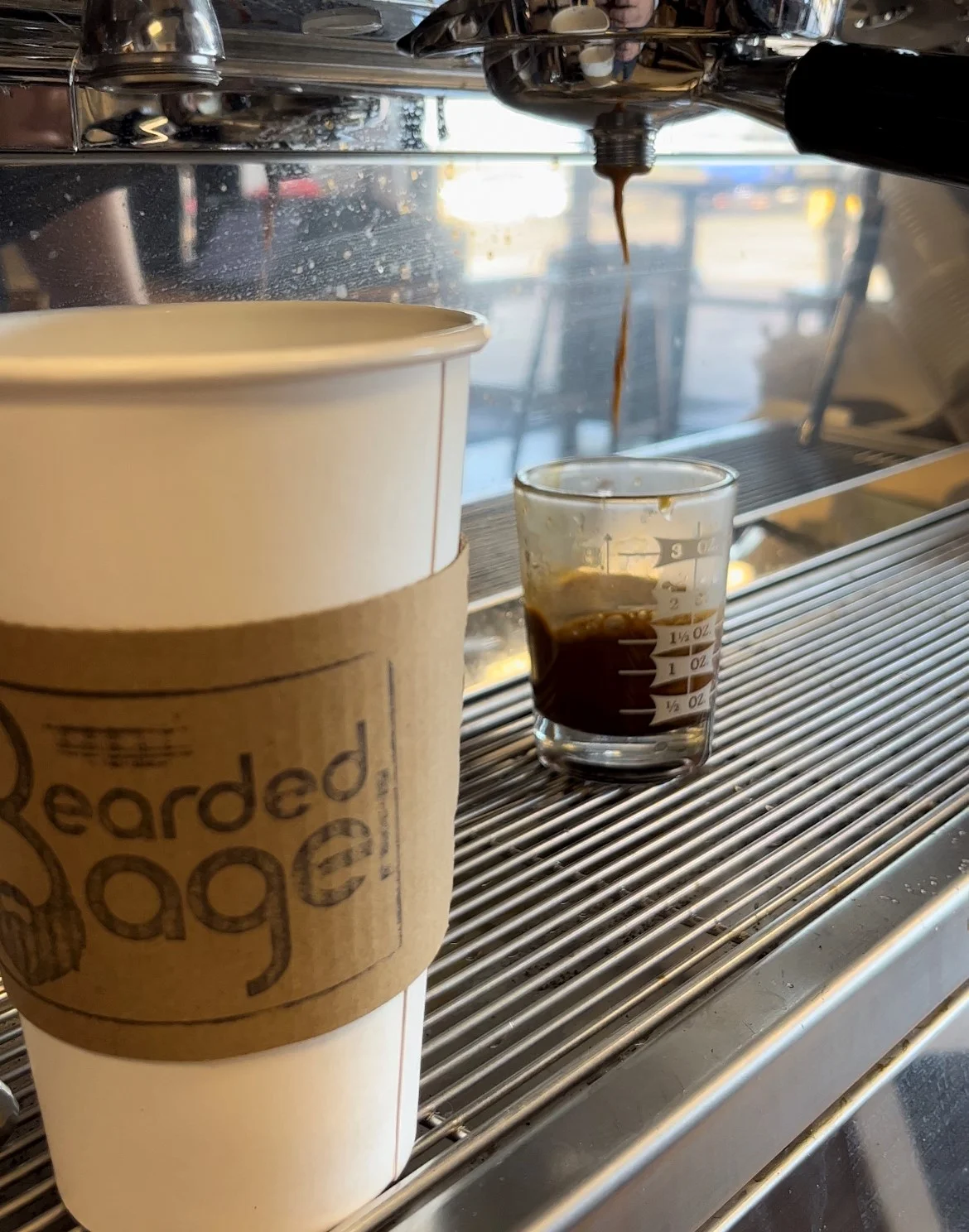 Freshly brewed espresso shot with coffee cup