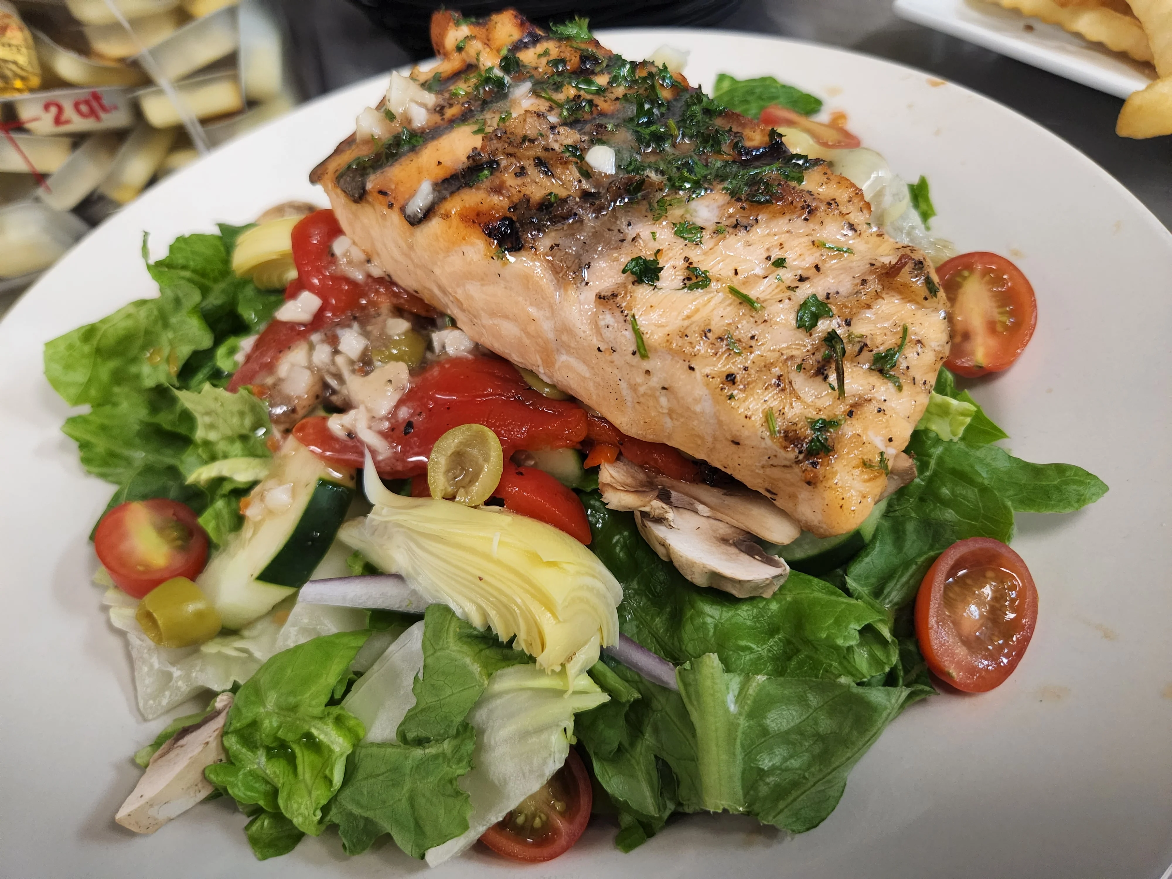 Grilled salmon salad with mixed greens and vegetables