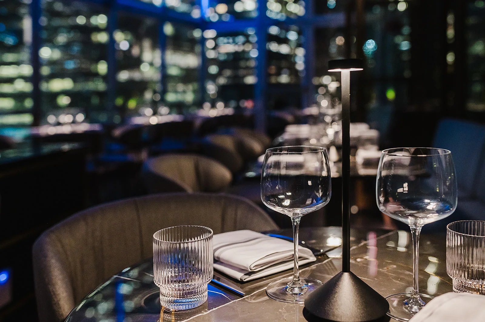 Elegant restaurant table setting with city skyline view