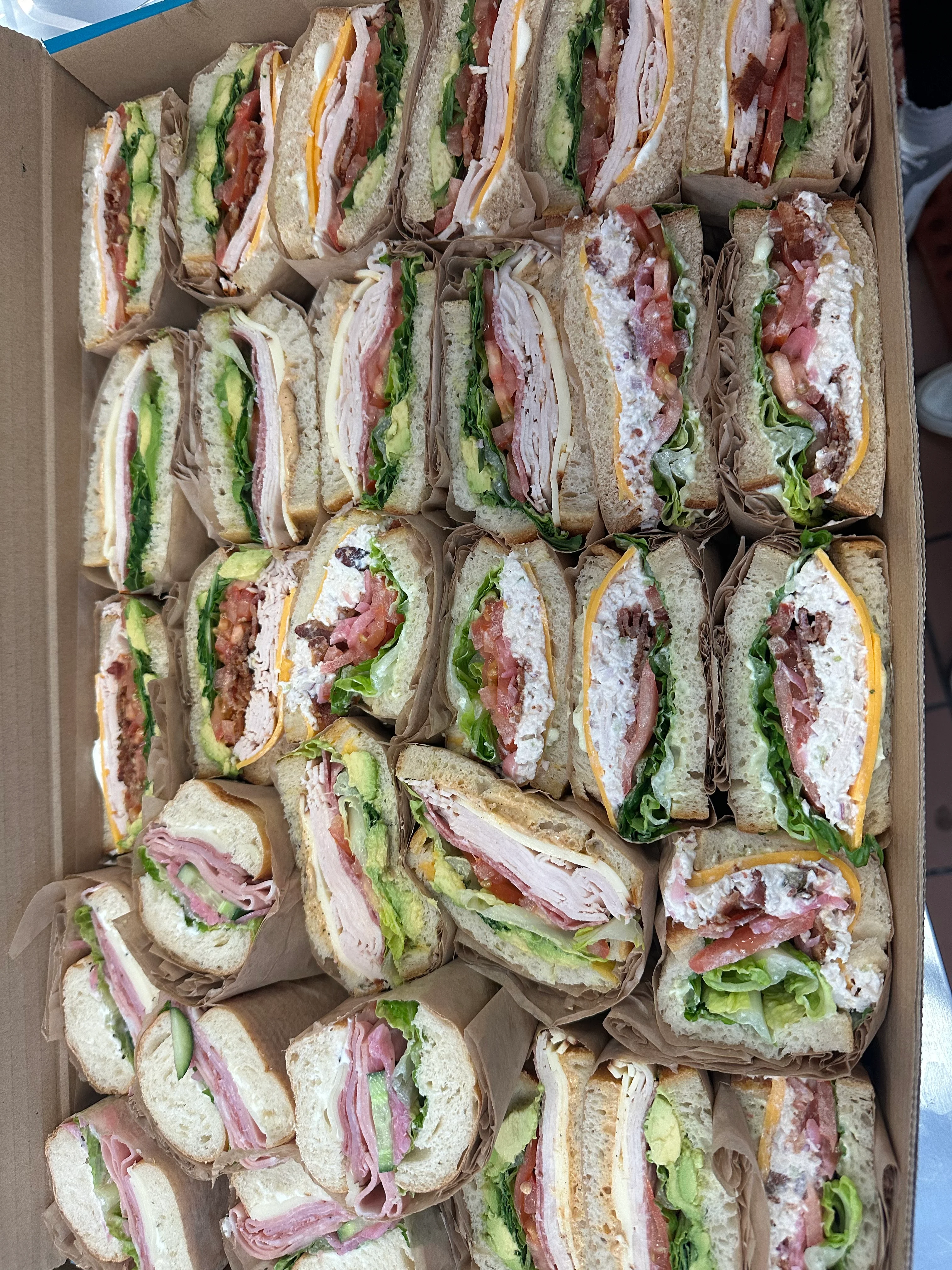 Assorted deli sandwiches in a catering box