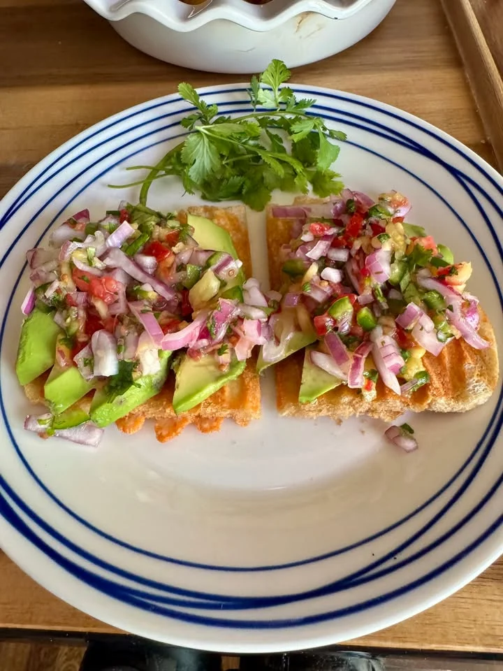 Mexican tostadas topped with fresh salsa and avocado