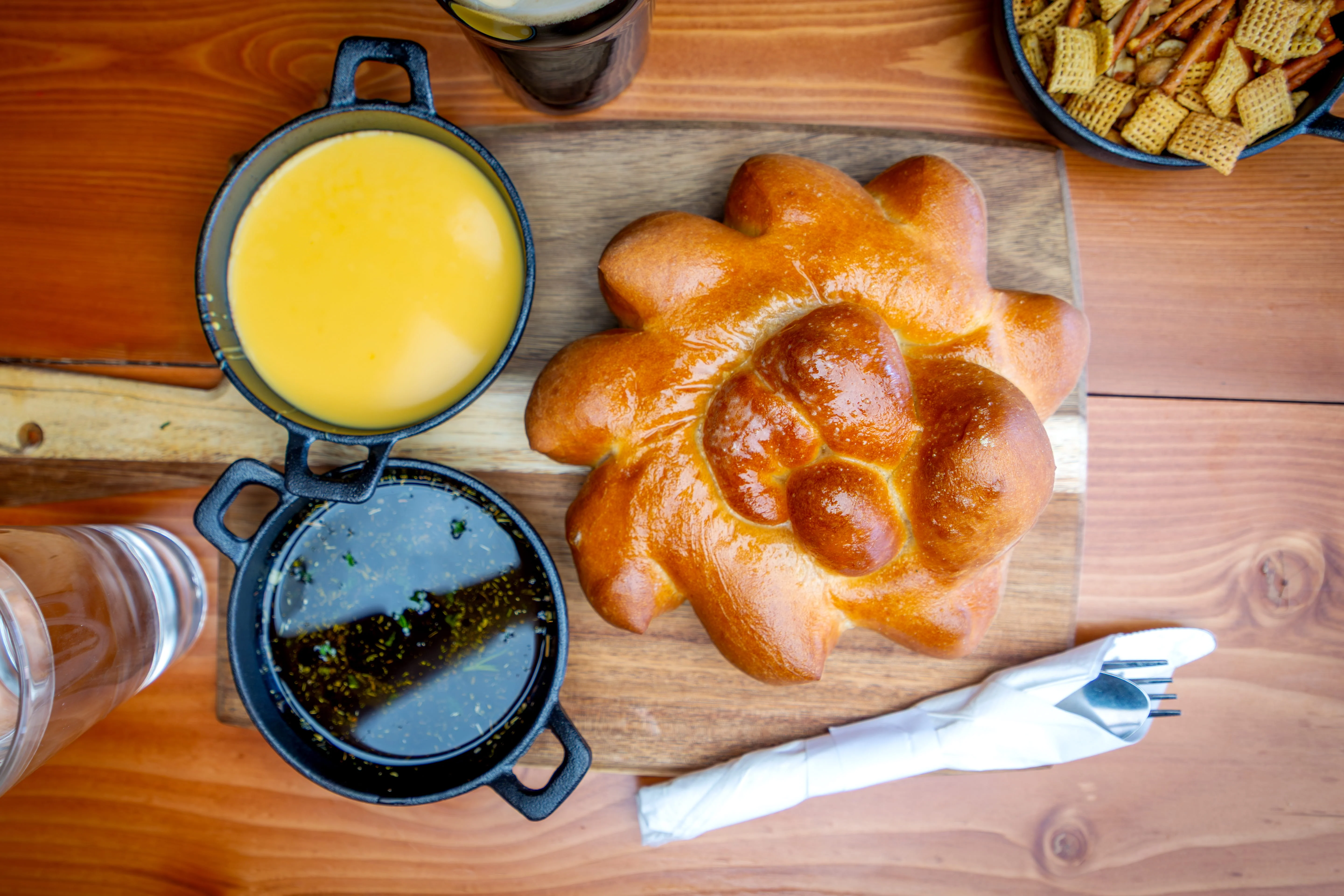 Freshly baked Mexican bolillo bread with dipping sauces
