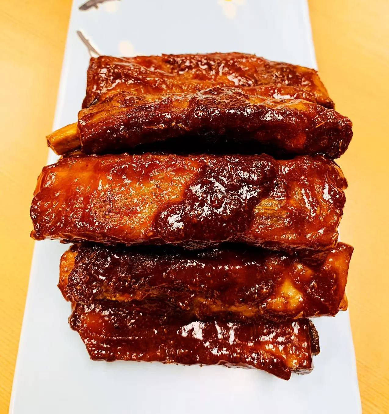 Succulent Chinese braised pork ribs on a decorative plate