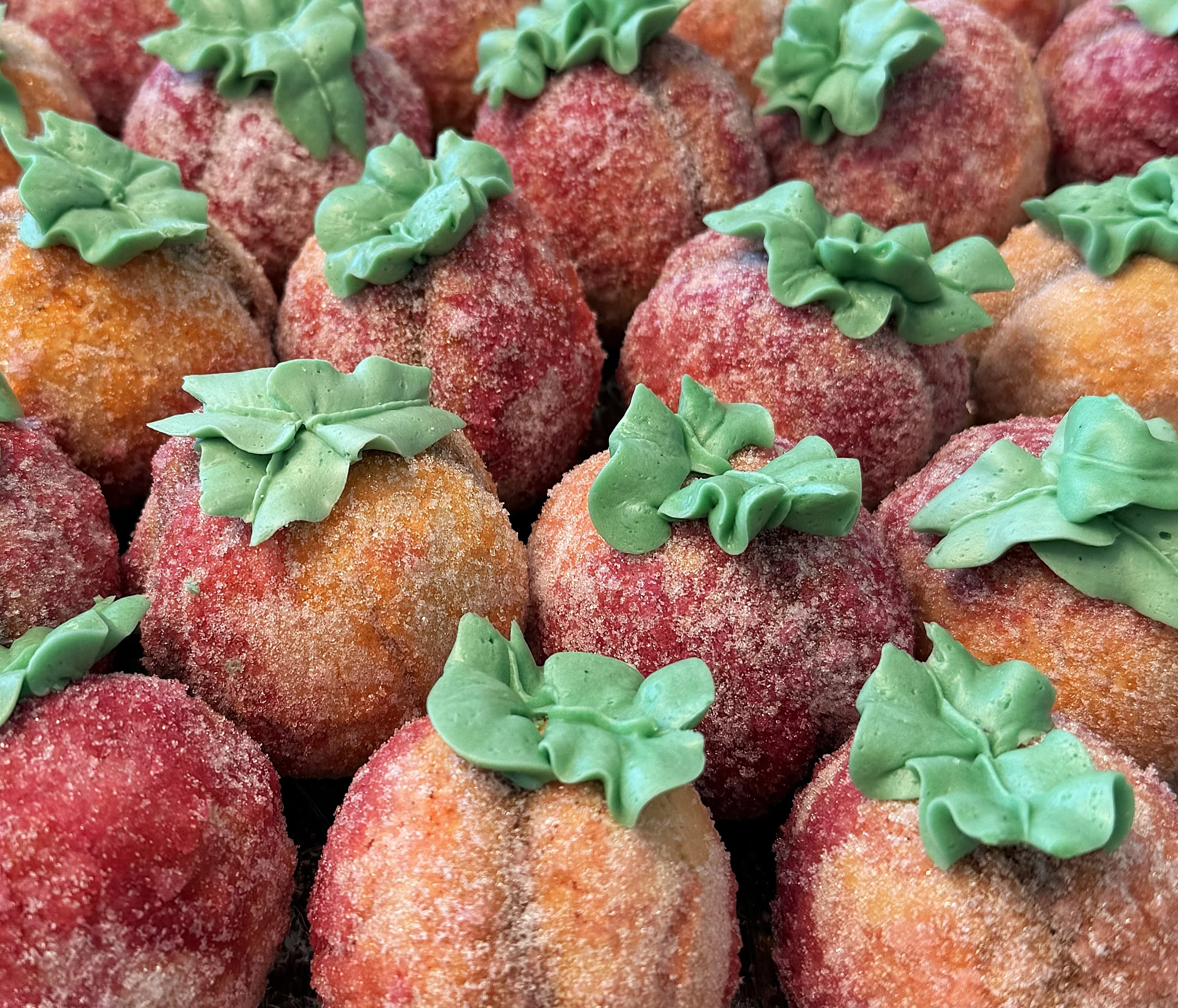 Italian peach-shaped cookies with green frosting