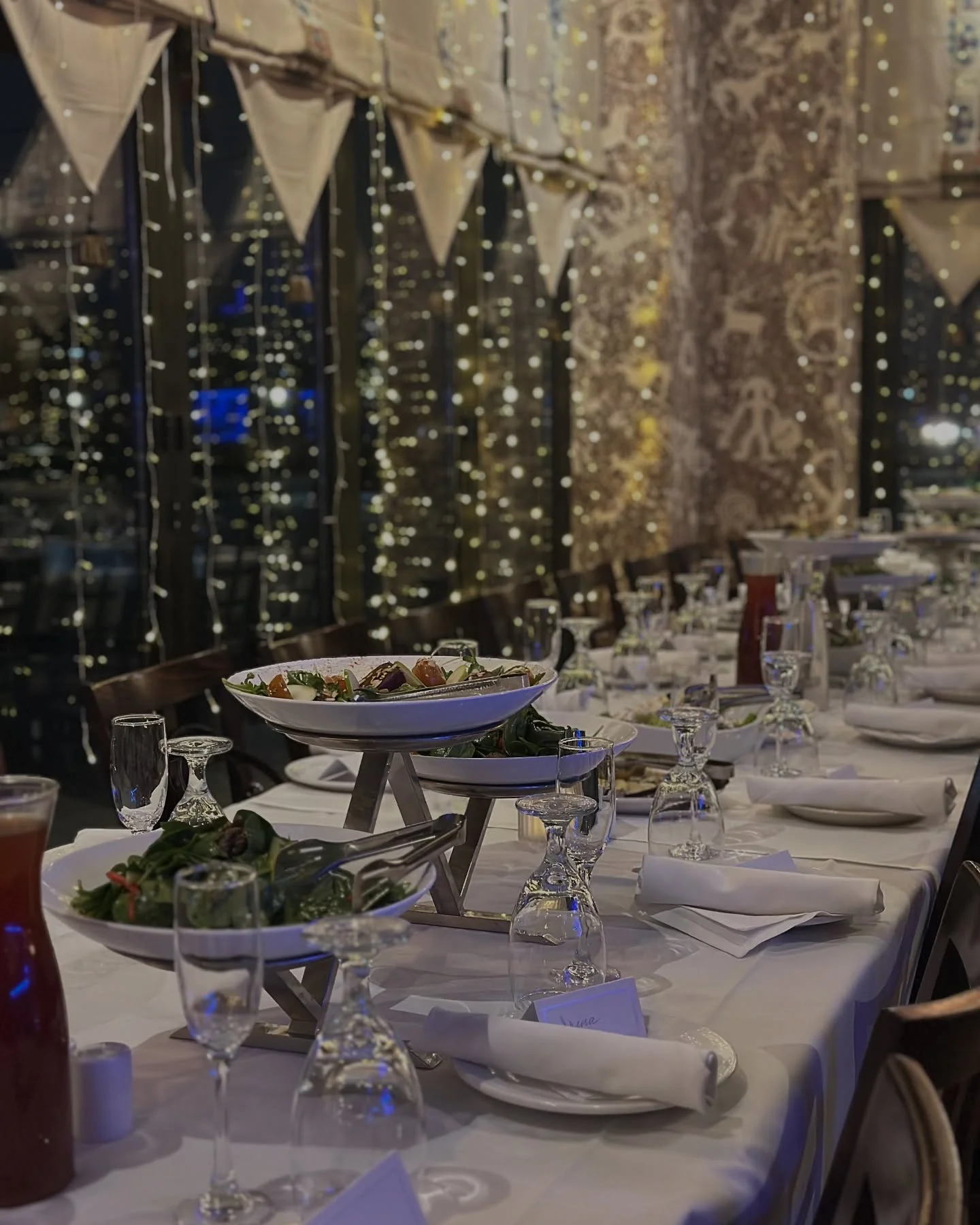 Elegant restaurant dining setup with festive lights
