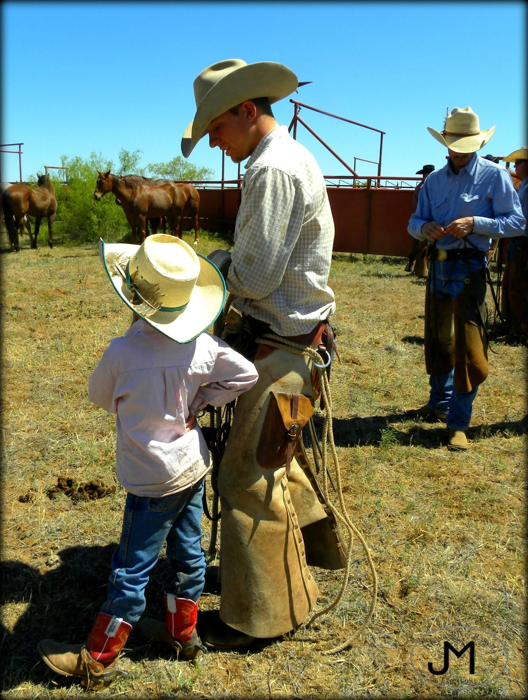 Cowboy and child interacting on a ranch