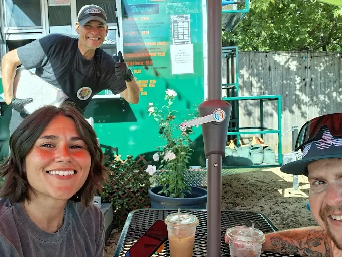 Friends enjoying drinks on a sunny restaurant patio