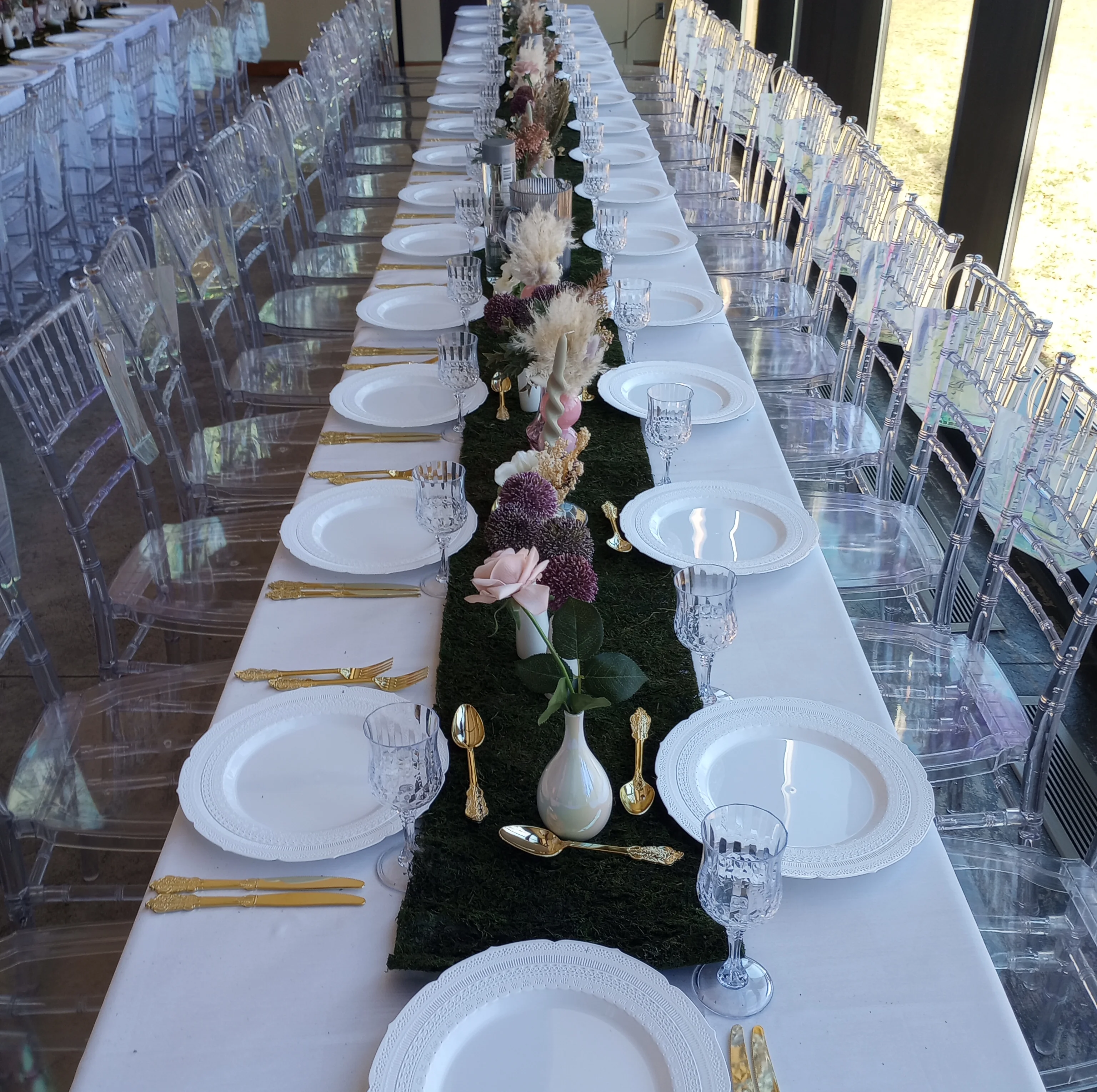 Elegant dining setup with floral centerpieces and crystal glassware