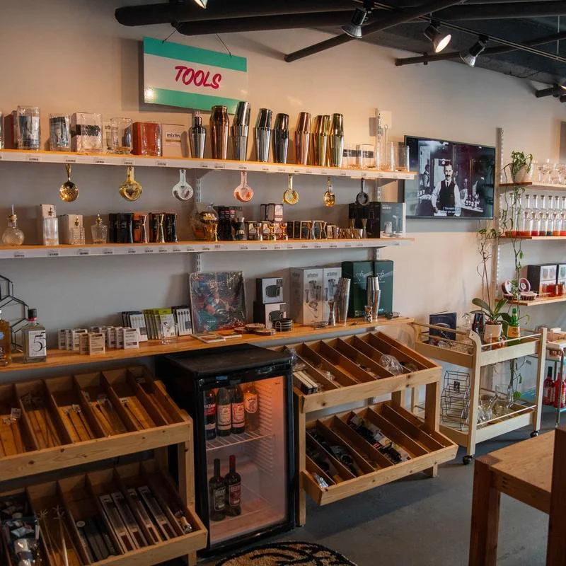Interior of a modern bar showcasing various cocktail tools and accessories.