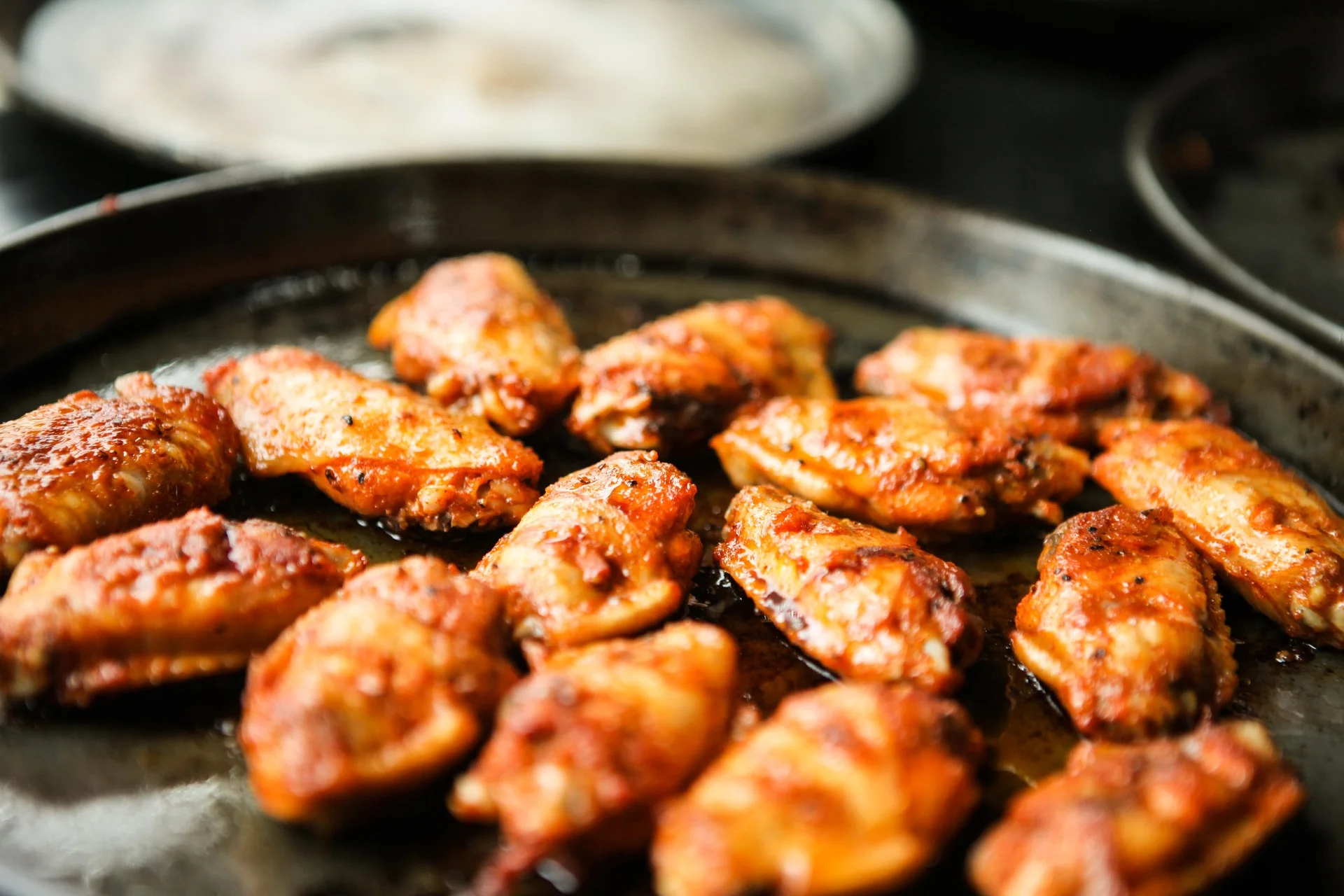 Crispy buffalo chicken wings on a serving platter
