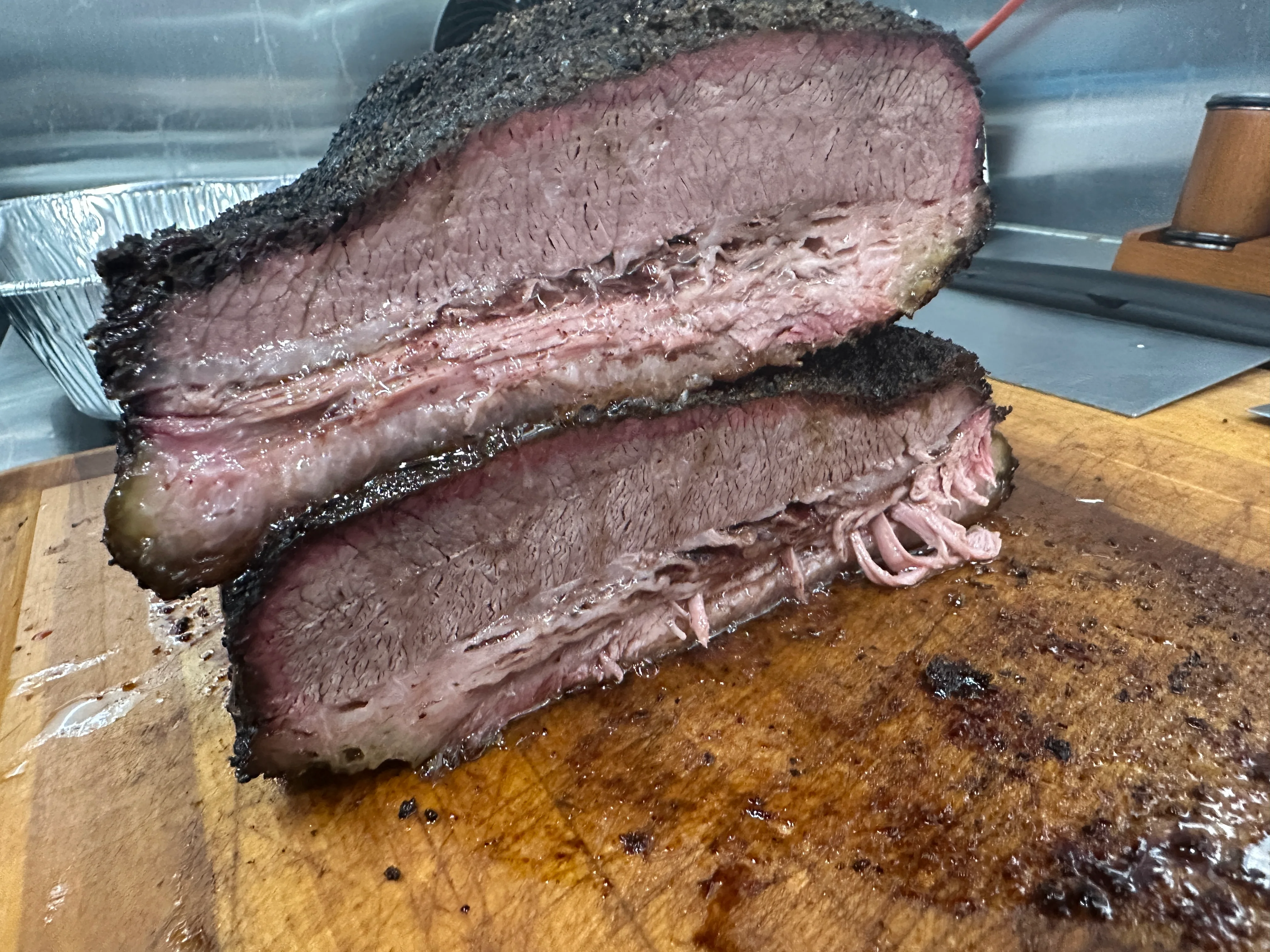 Smoked Texas brisket sliced on a wooden cutting board