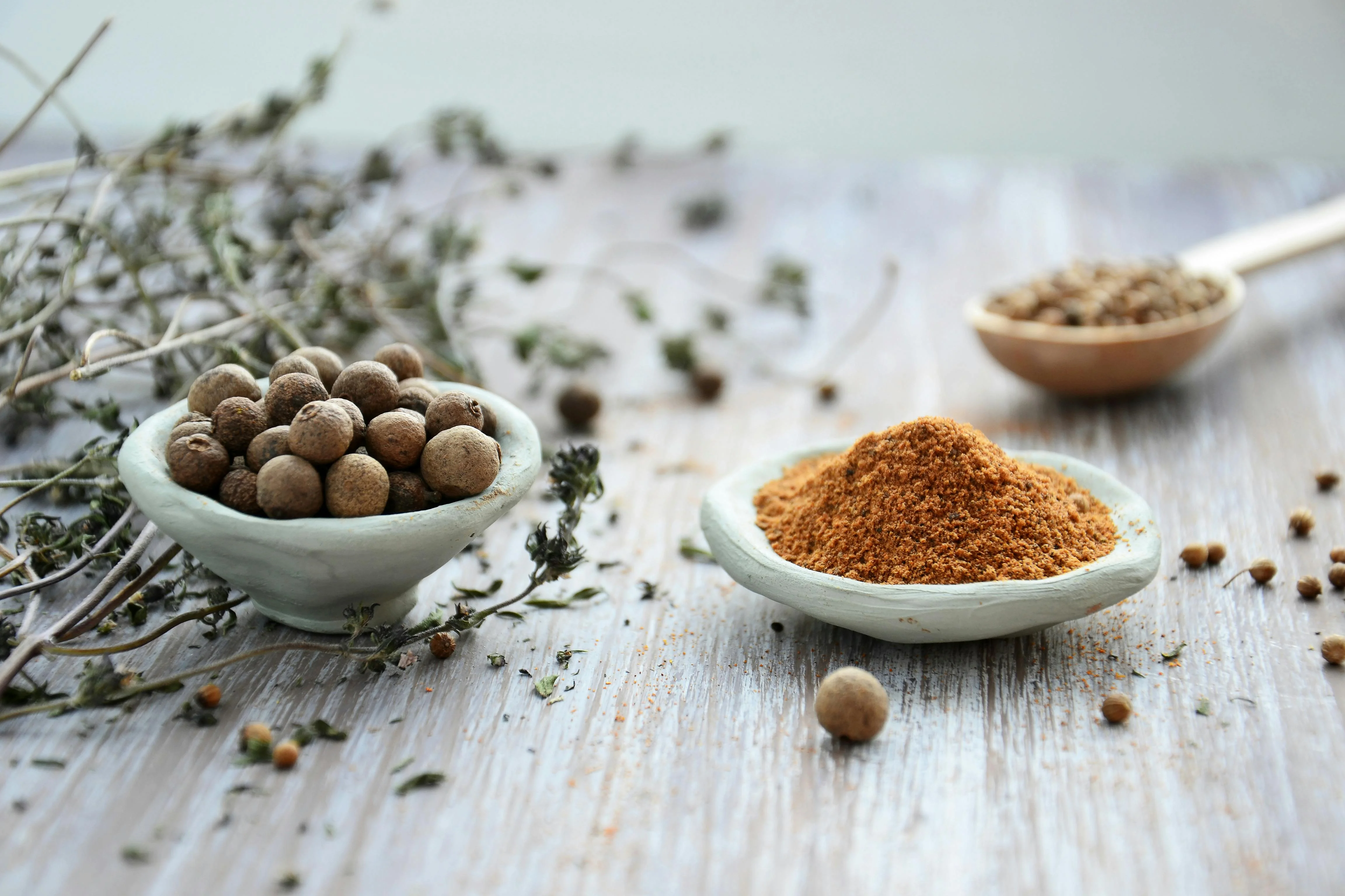 Variety of spices in traditional bowls for culinary use