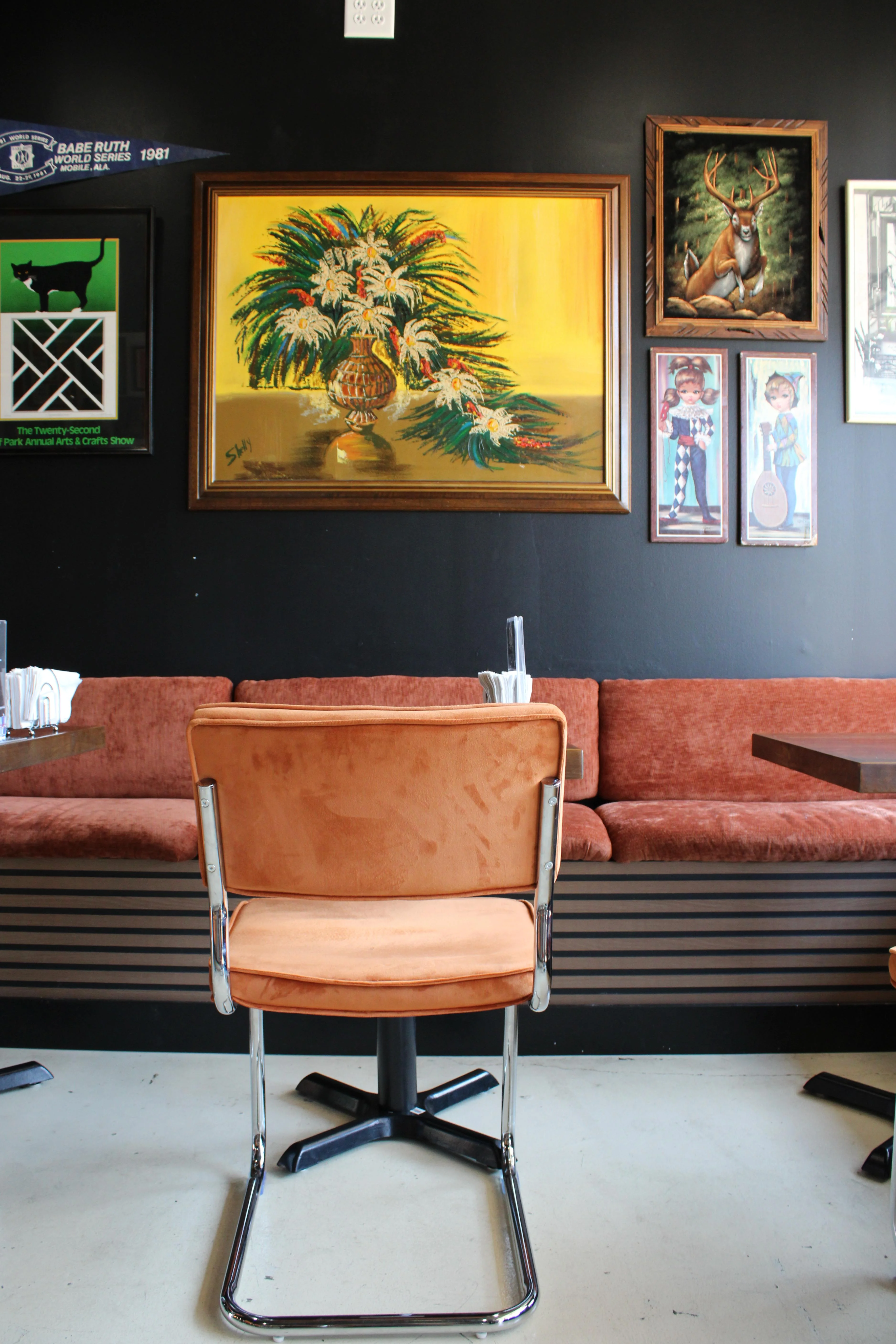 Cozy restaurant interior with colorful artwork and plush seating
