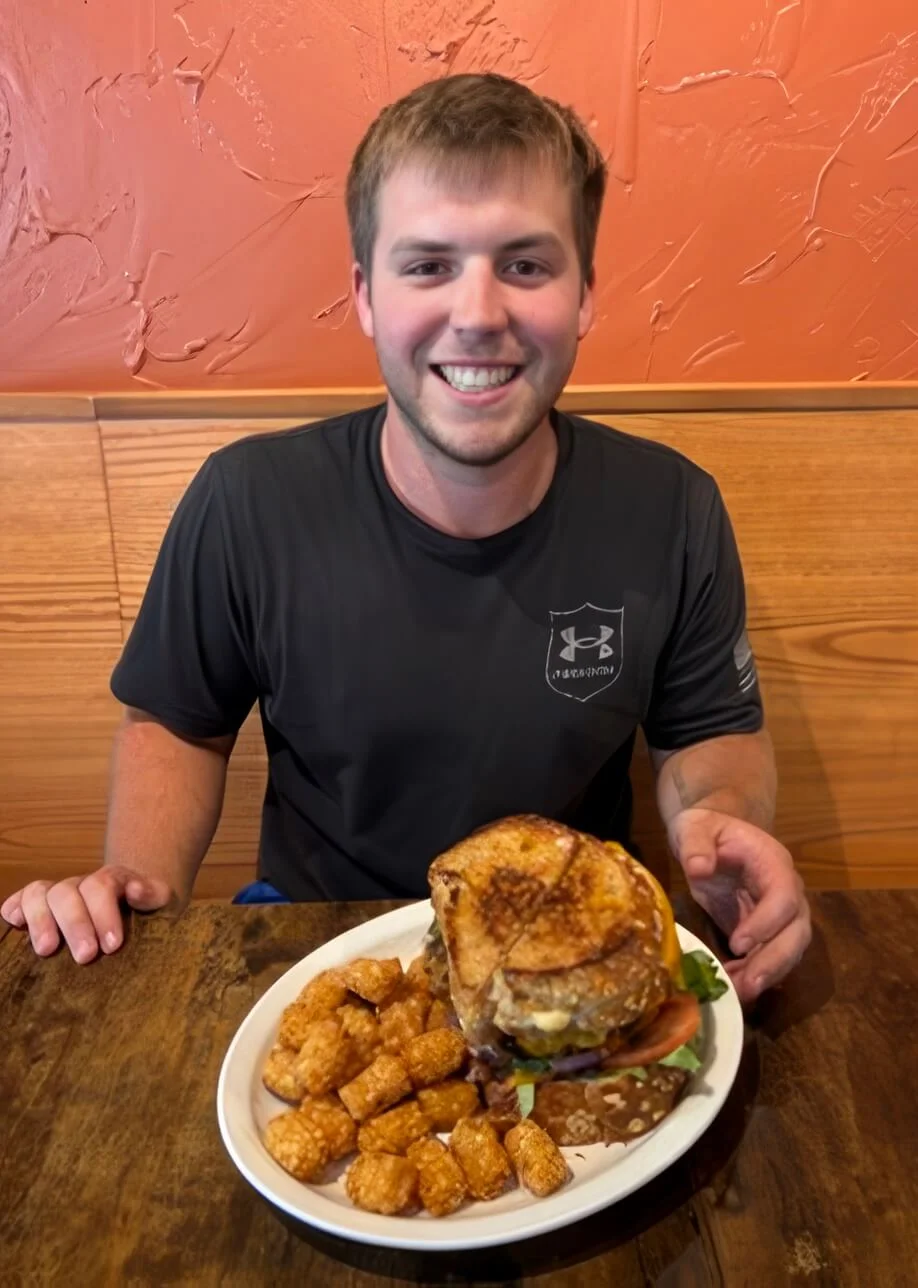 Juicy cheeseburger with tater tots in a casual dining setting