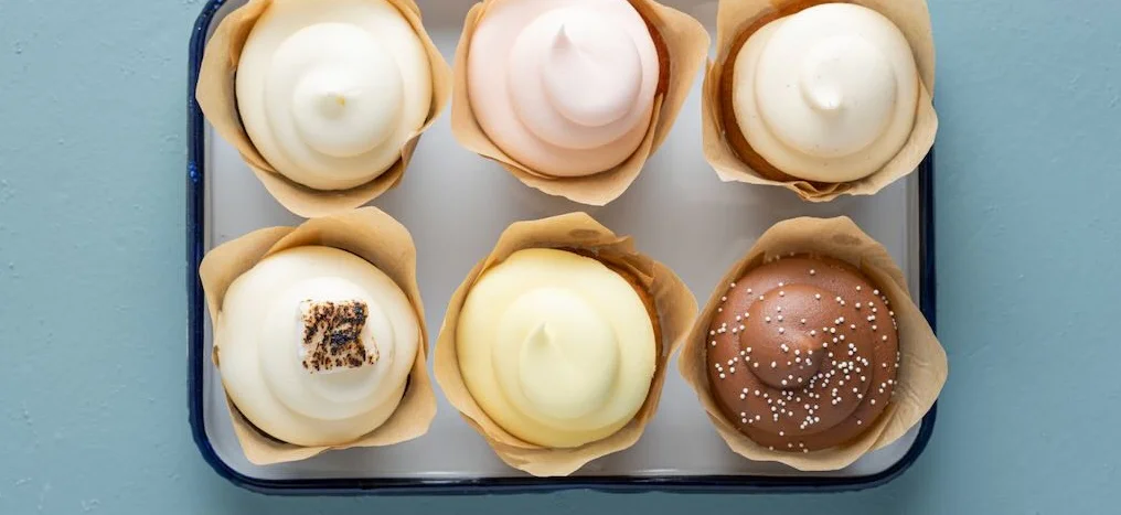 Assorted gourmet cupcakes in decorative wrappers