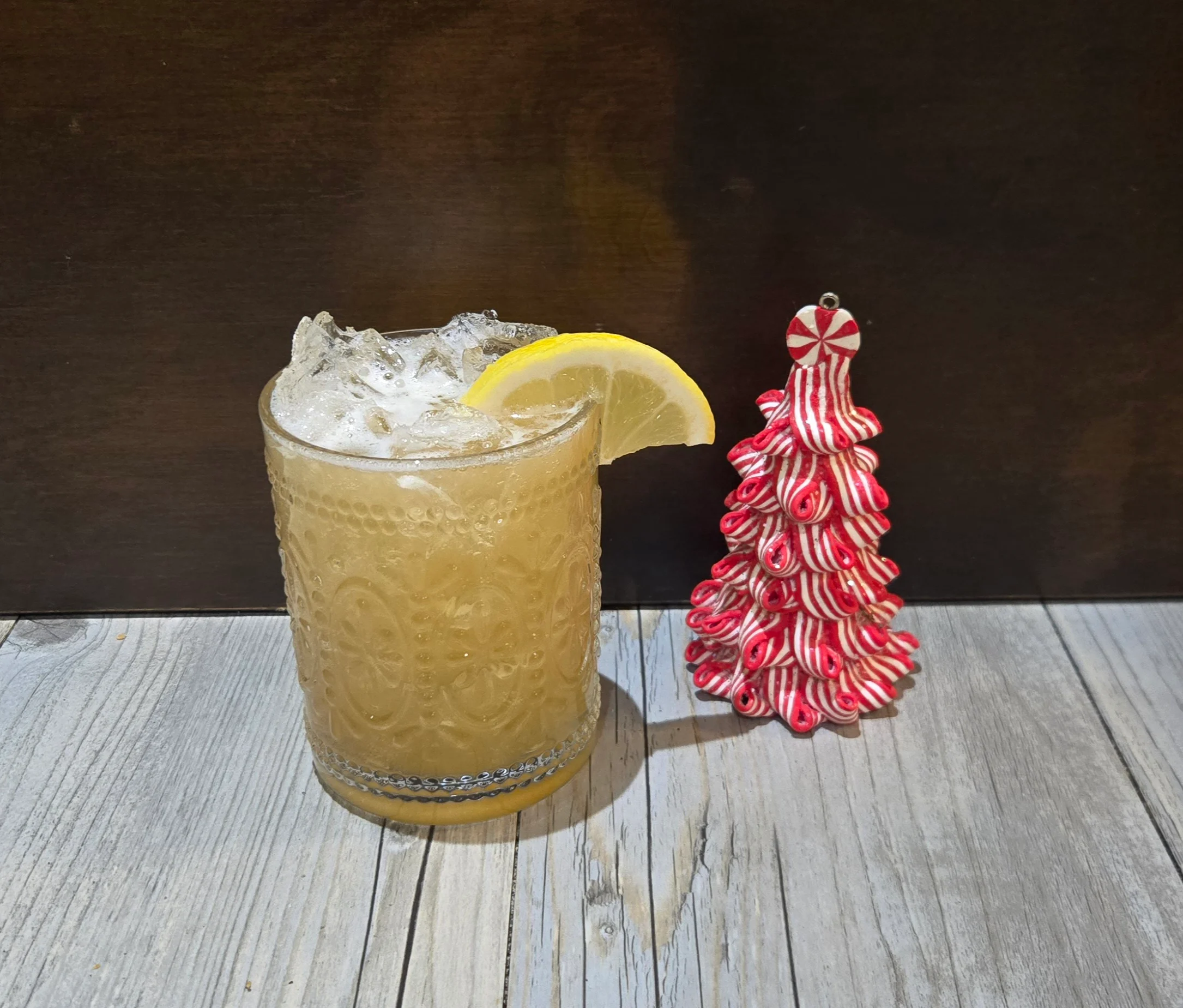 Refreshing cocktail with lemon garnish and festive decor