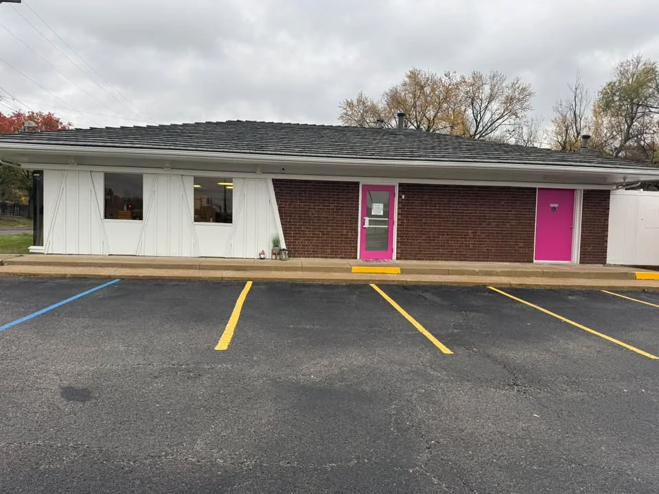 Exterior view of a modern restaurant with pink accents
