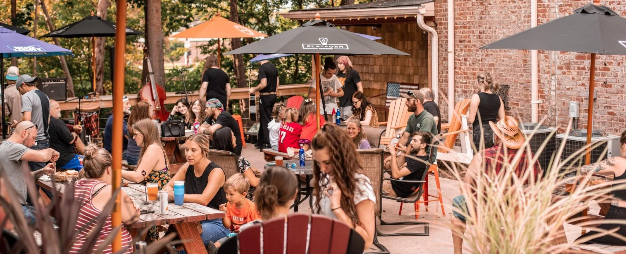 Outdoor dining scene with guests enjoying food and drinks