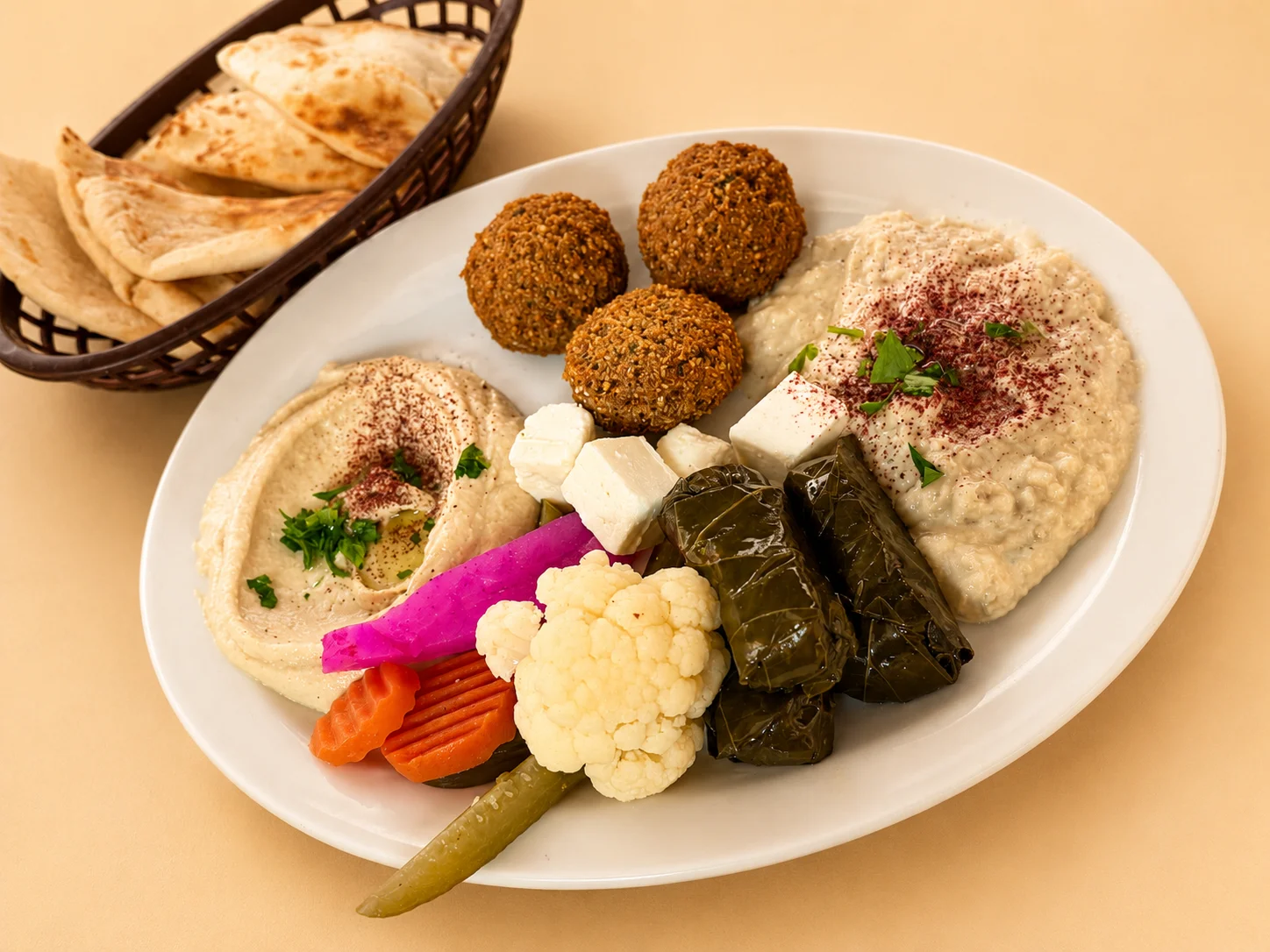 vegetarian combo plate that is vegetarian includes three falafels hummus babaganoush eggplant tahini pickled turnips and arabic pickles and our home made bread