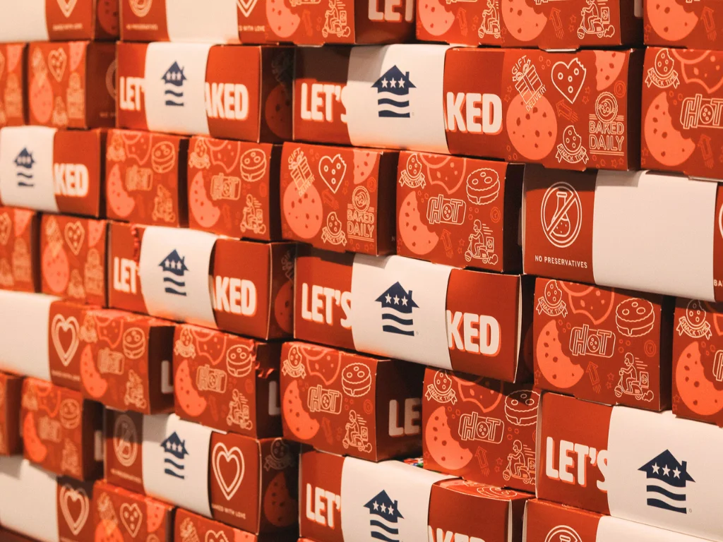 Colorful cookie boxes stacked in a bakery display