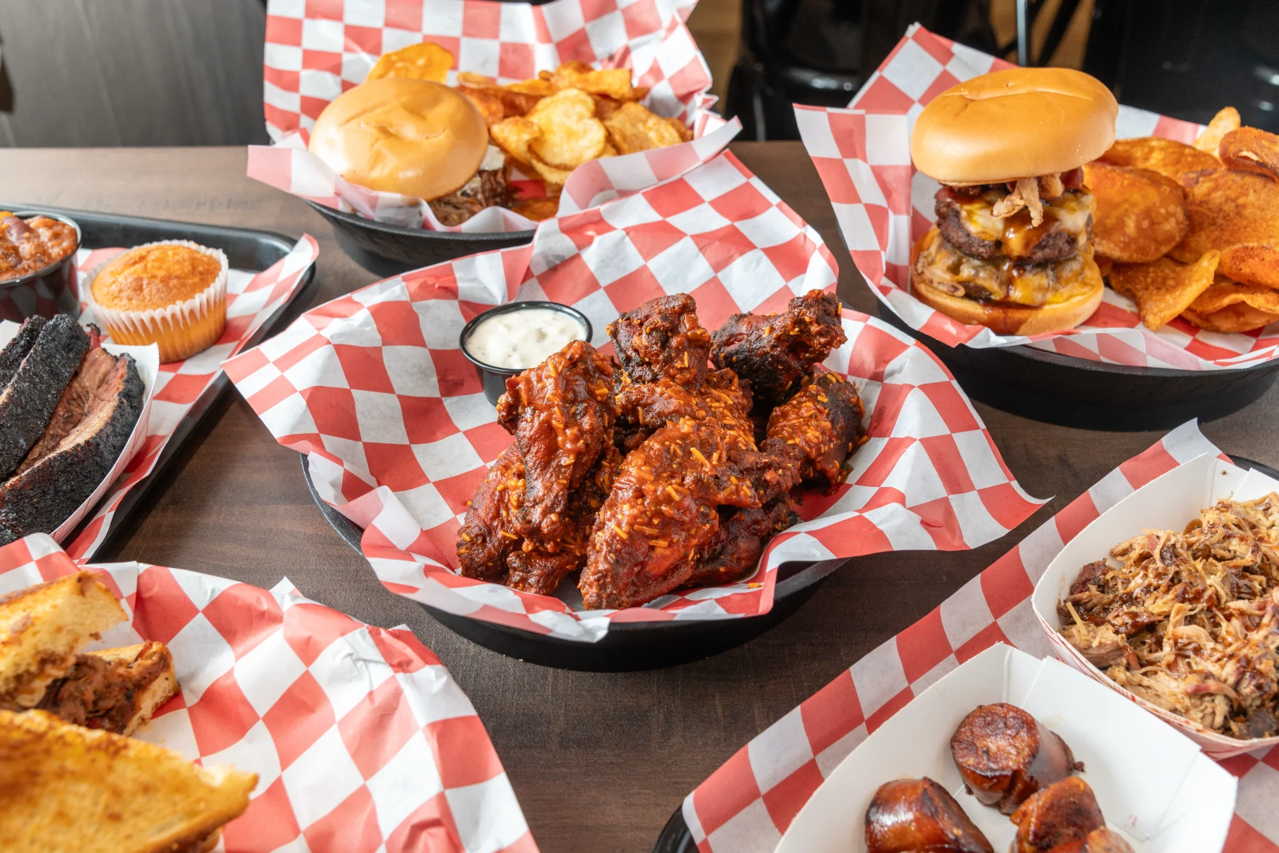 Platter of American barbecue wings with sides in a casual dining setting