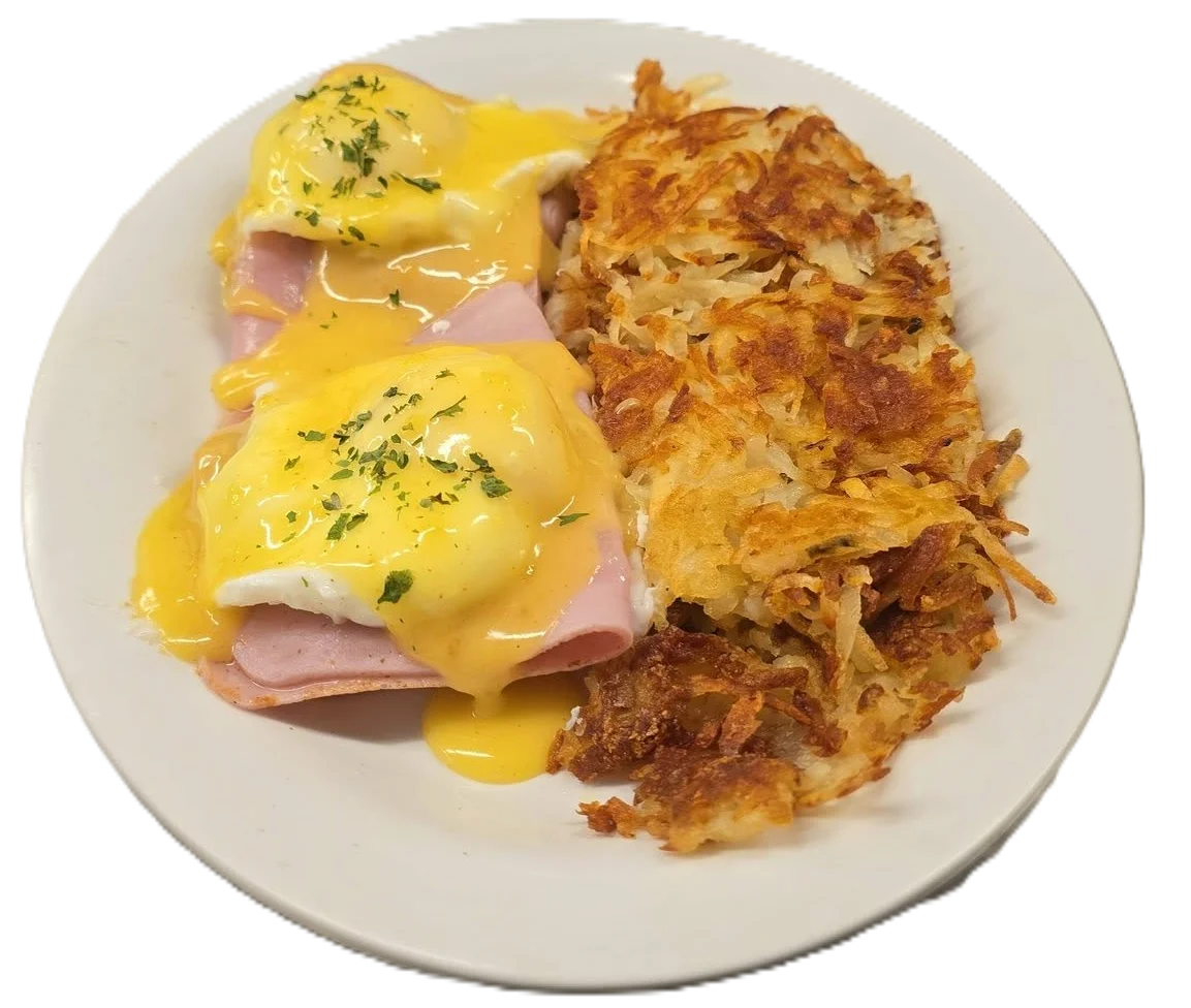 Classic Eggs Benedict with hollandaise sauce and hash browns