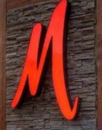 Moxie Wood-Fire Grill sign with a sunset backdrop
