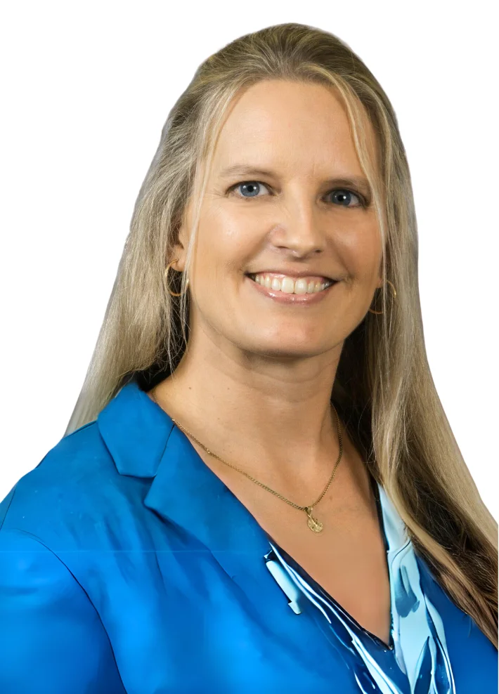 Professional headshot of a smiling woman in a blue blouse
