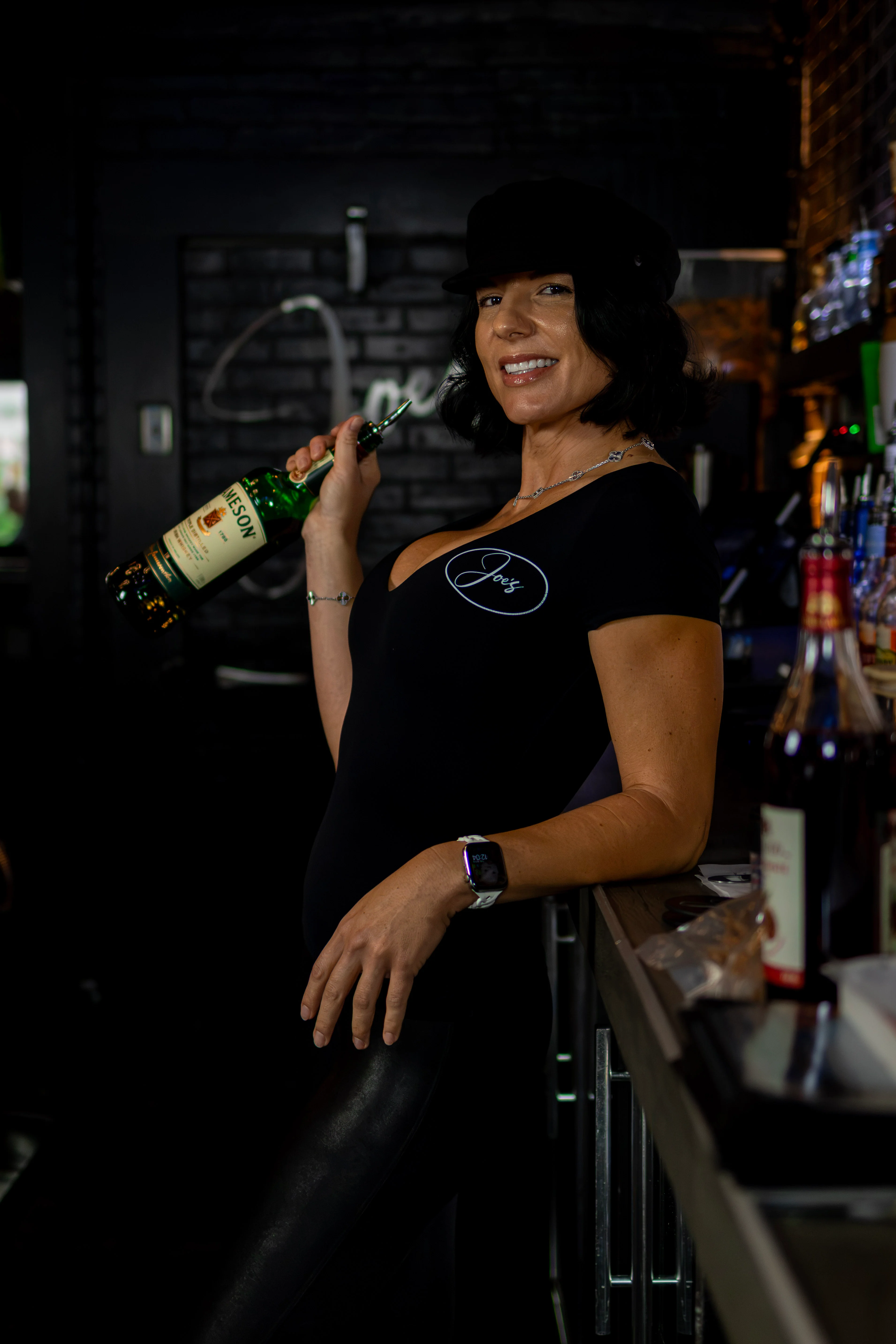 Bartender smiling at a modern bar counter with stylish decor