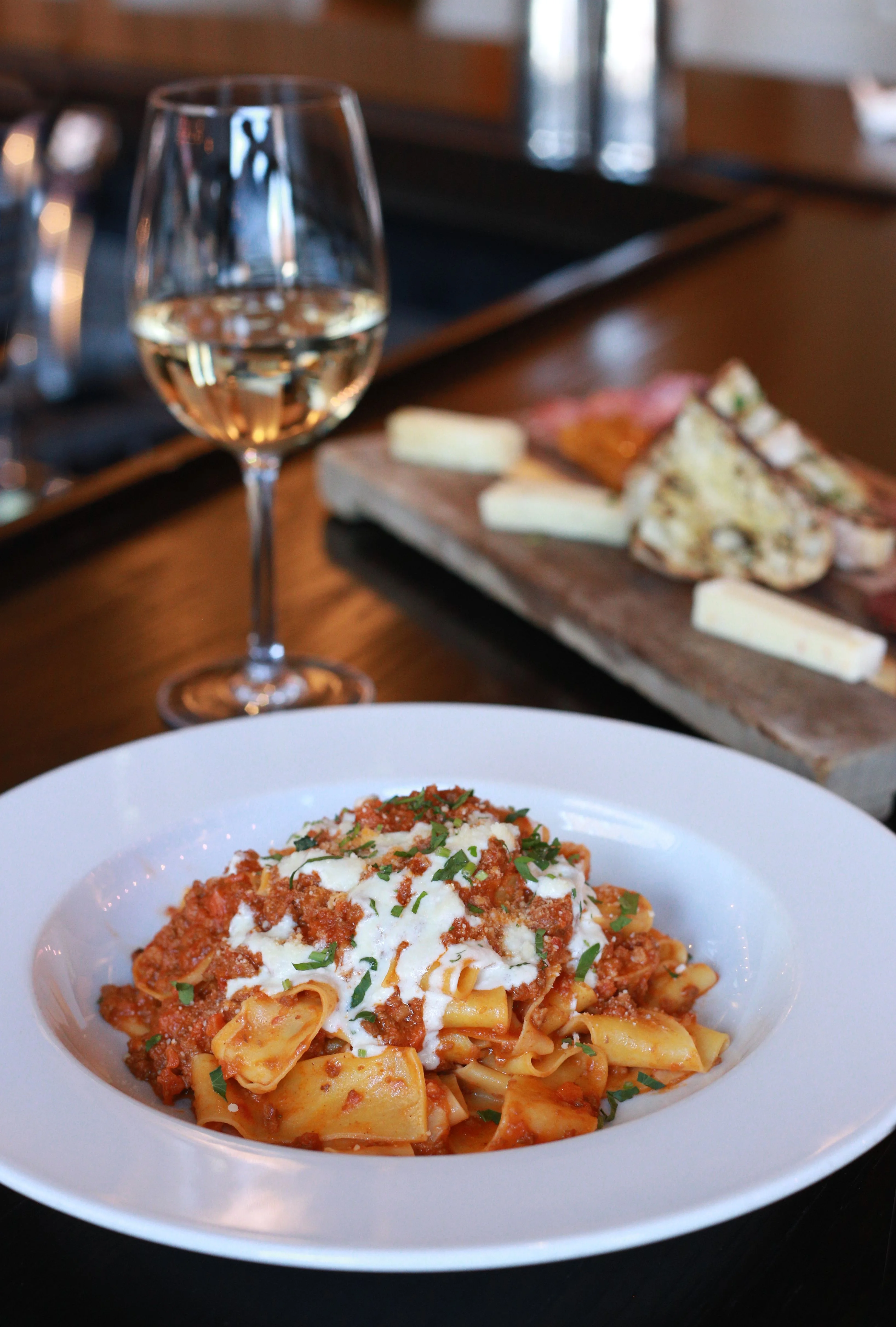 Plate of Italian pappardelle with meat sauce and cheese