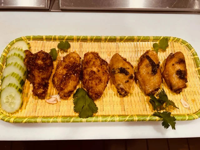 Crispy Thai-style chicken wings on a bamboo platter