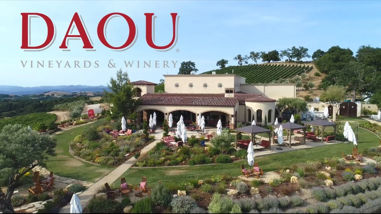 Aerial view of a California winery estate with vineyards and outdoor seating