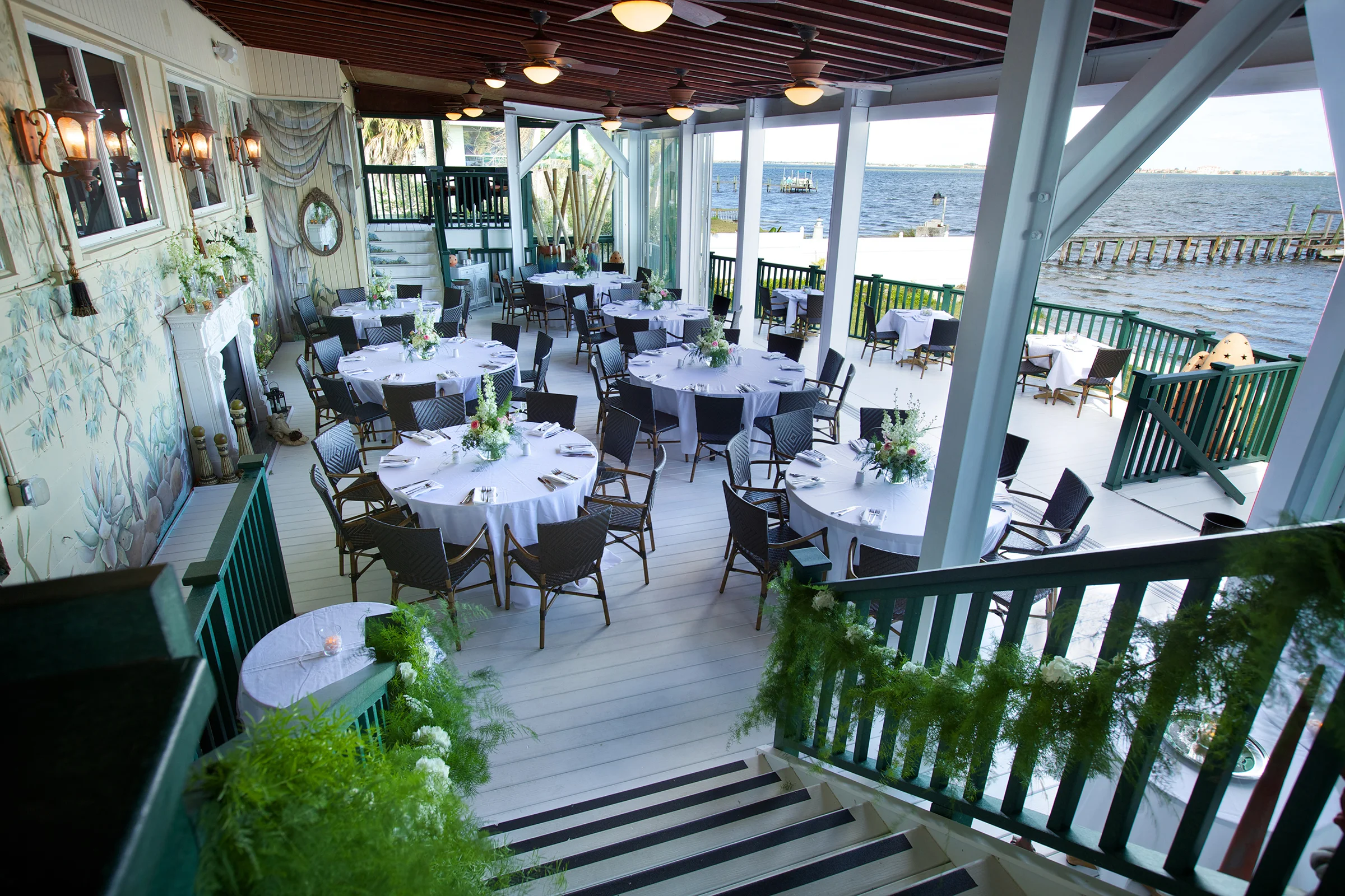 Elegant waterfront dining area with round tables