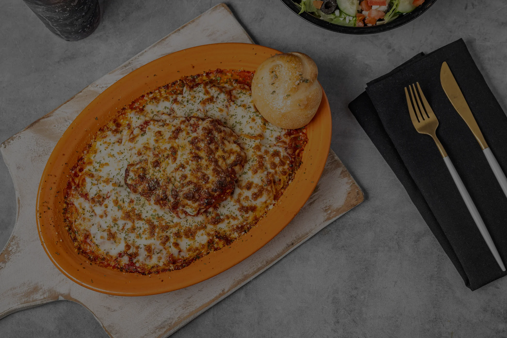 Baked lasagna with cheese in a rustic dish