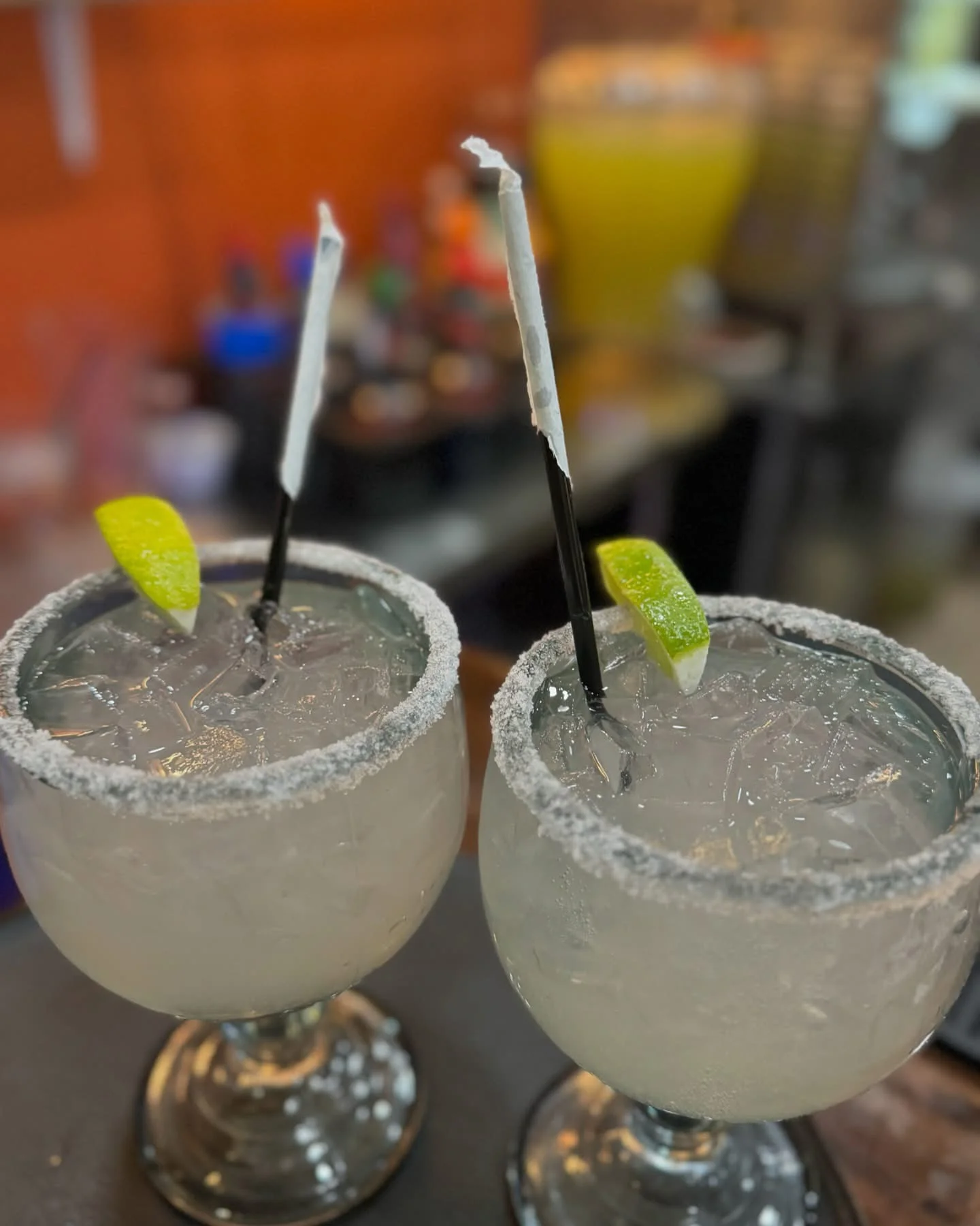 Refreshing margaritas with lime garnish and salt rim