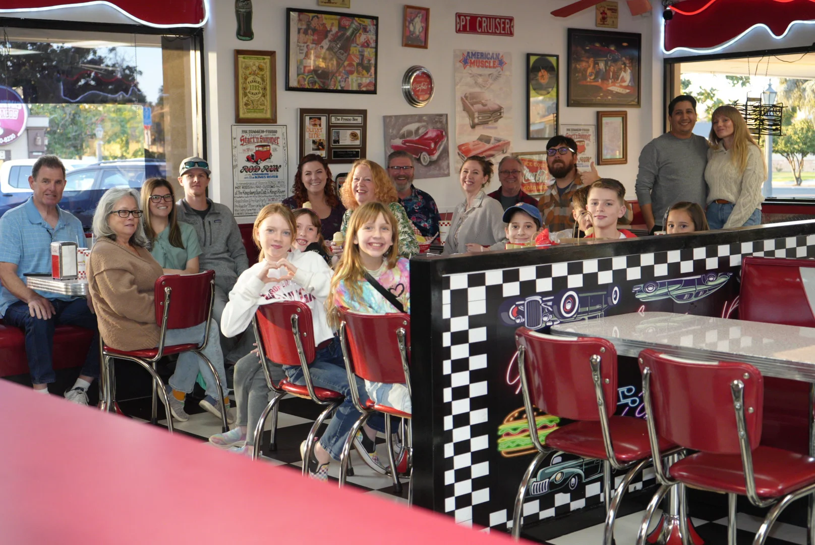 Group of friends enjoying a meal in a retro diner setting