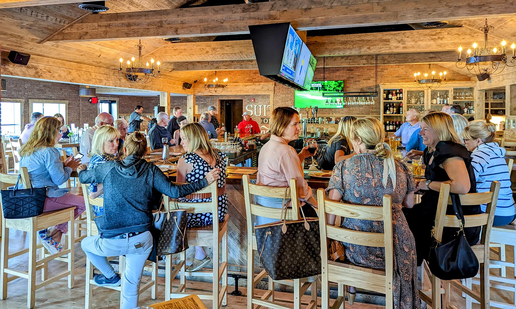 Lively restaurant bar scene with patrons enjoying drinks