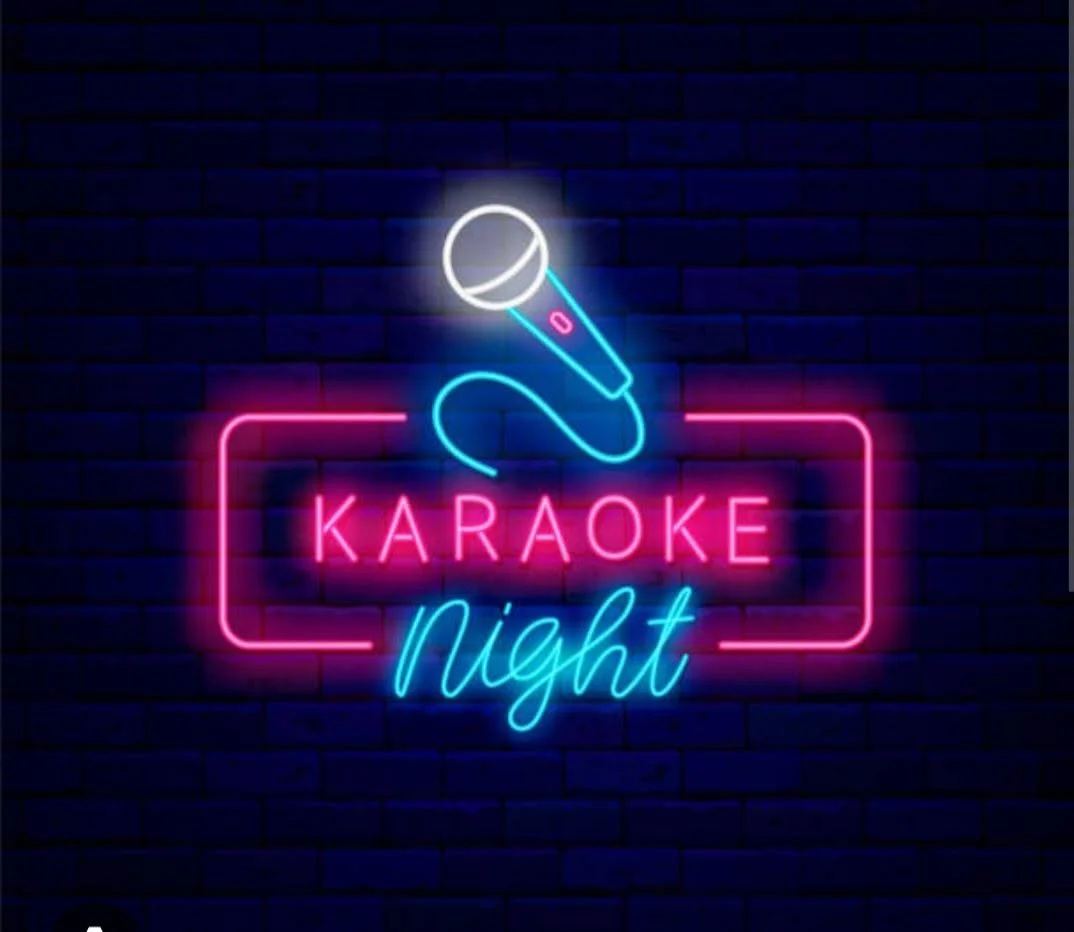 Neon karaoke night sign with microphone on a brick wall