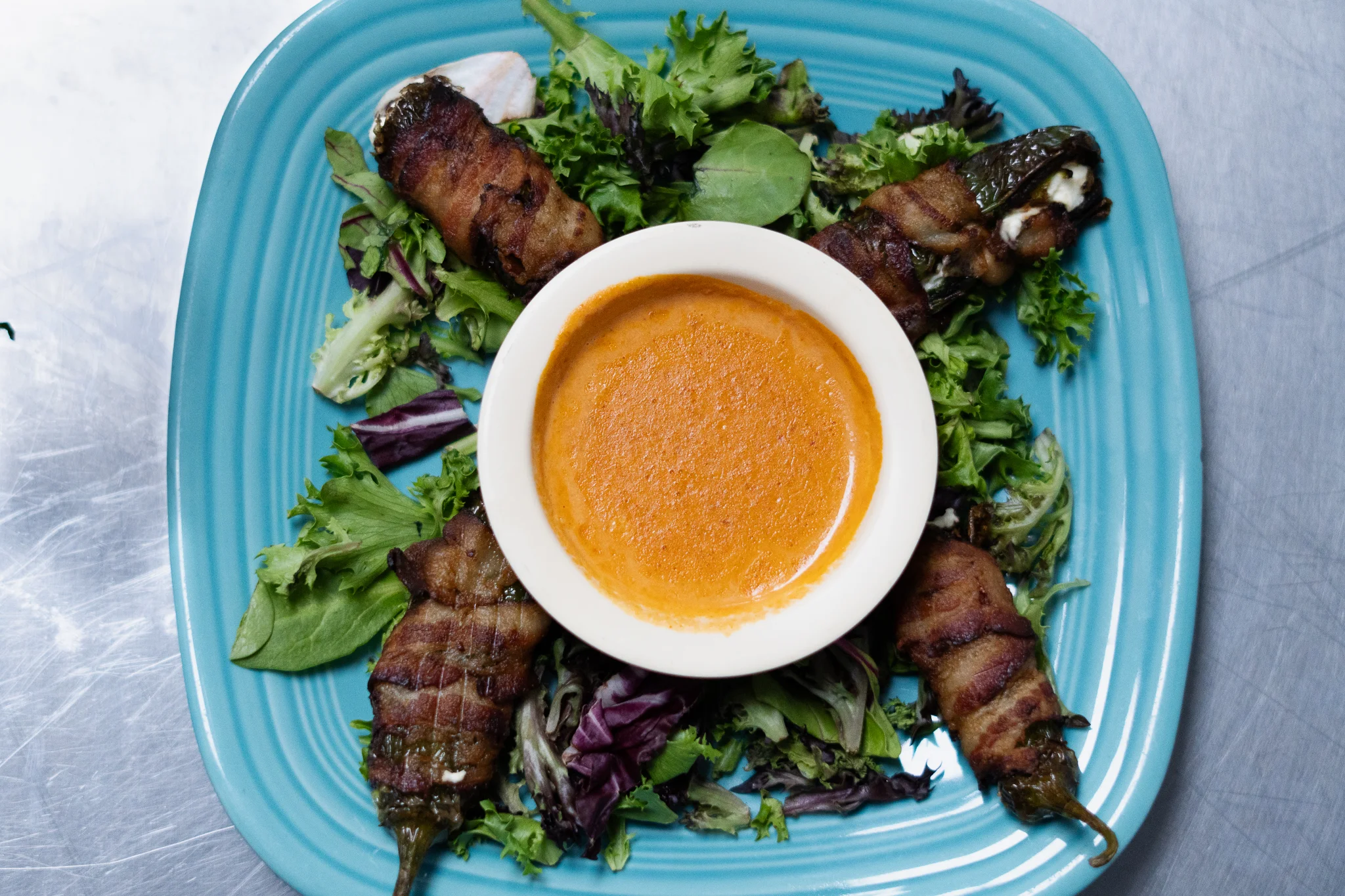Bacon-wrapped jalapeño poppers with dipping sauce