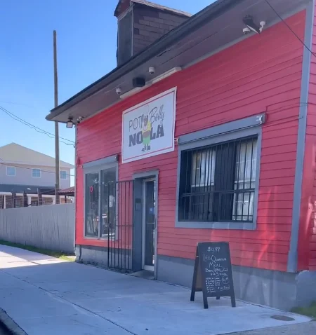 Exterior of Pot Belly NOLA restaurant with vibrant red facade